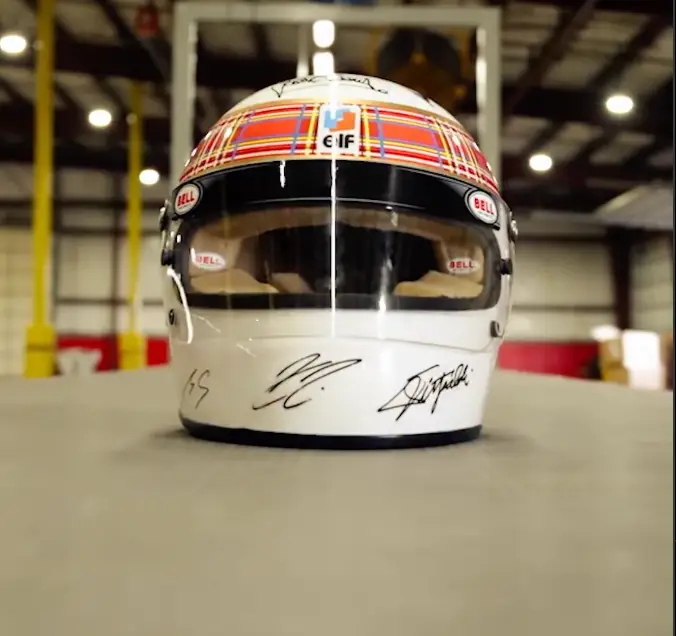 The helmet signed by all living F1 champions (Schumacher's autograph visible far left) (Image: Instagram/@dhlmotorsports)