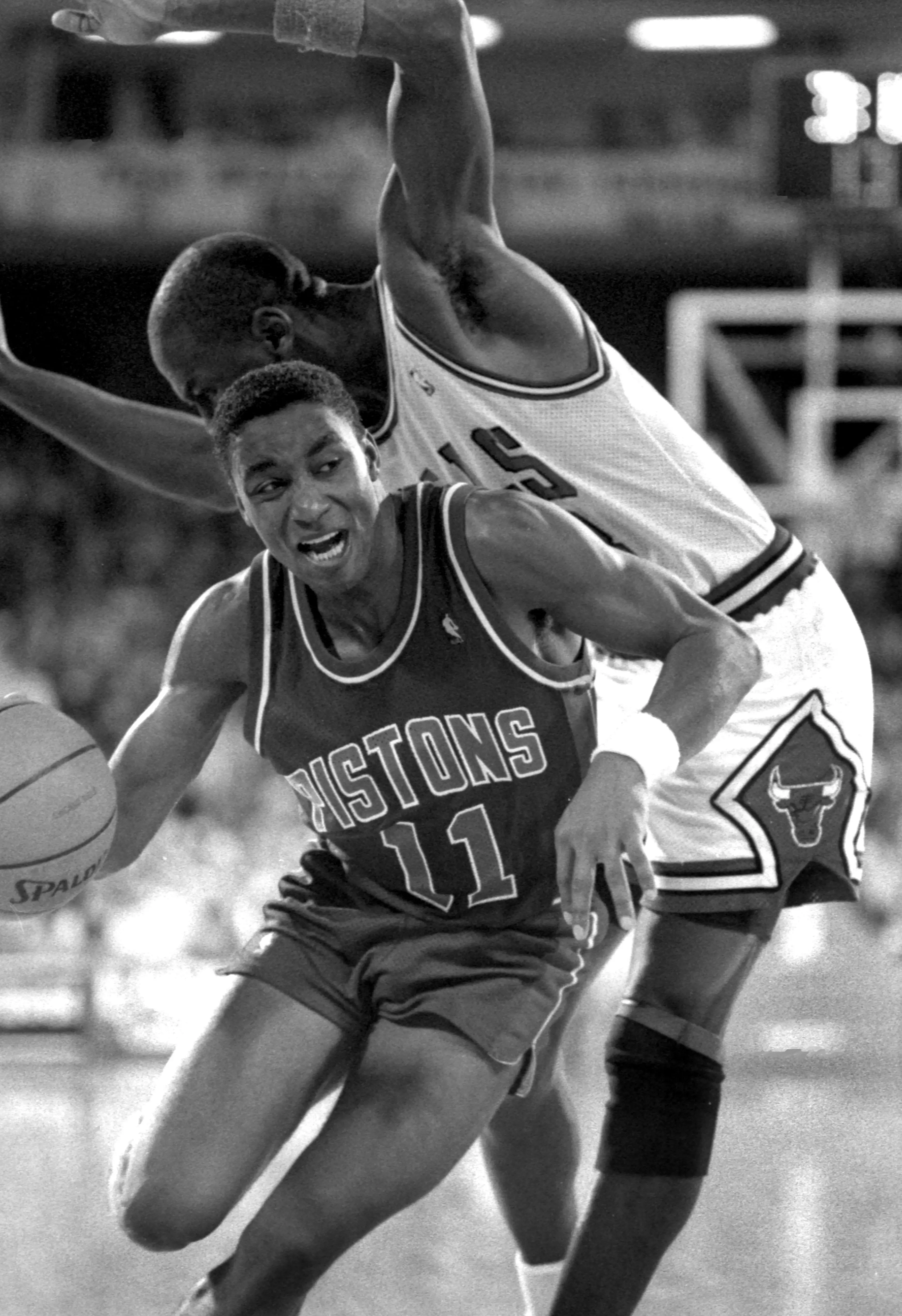 Isiah Thomas drives past Michael Jordan.