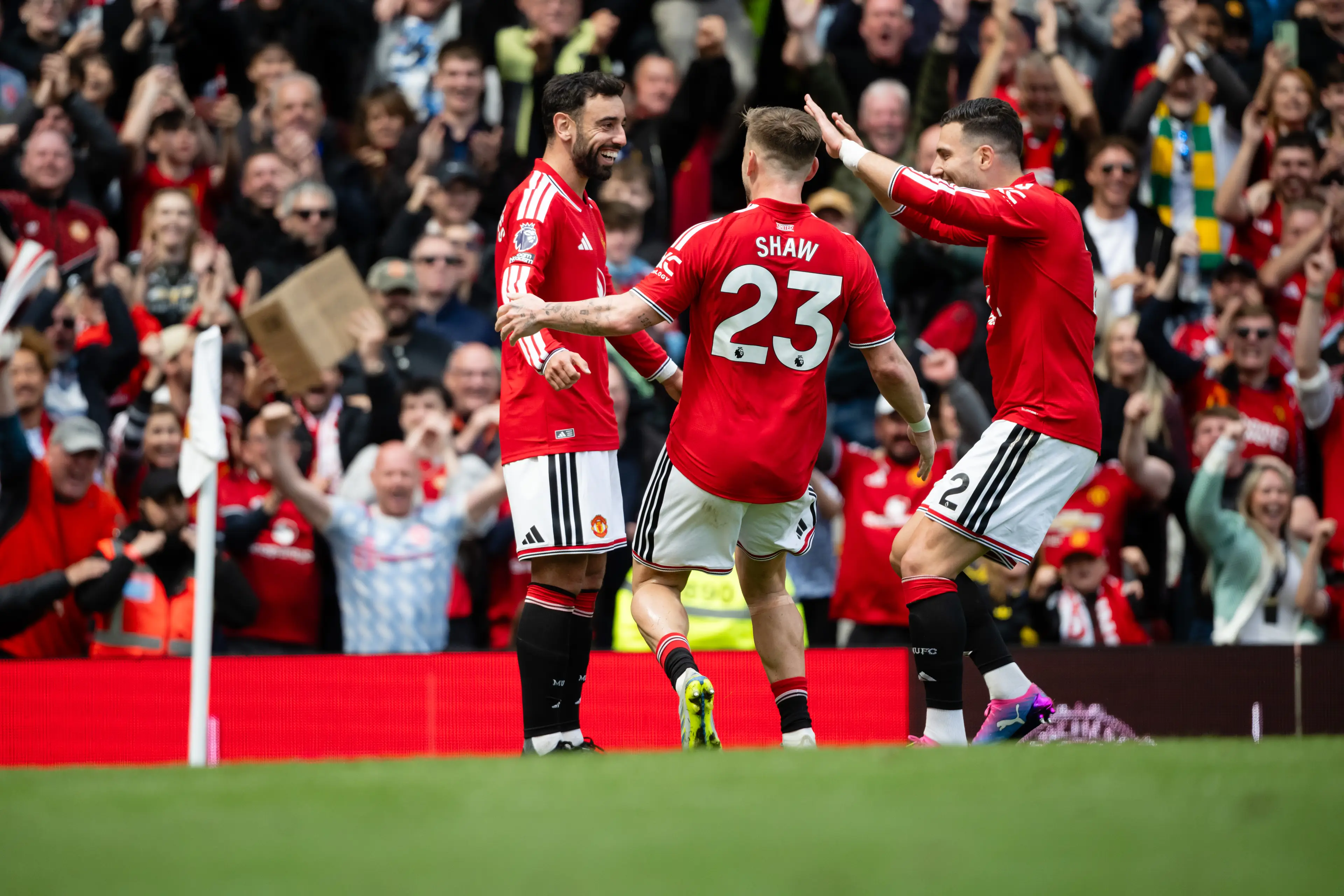 Bruno Fernandes celebrates with Luke Shaw and Diogo Dalot after Bryan Mbeumo's goal. Image credit: Getty