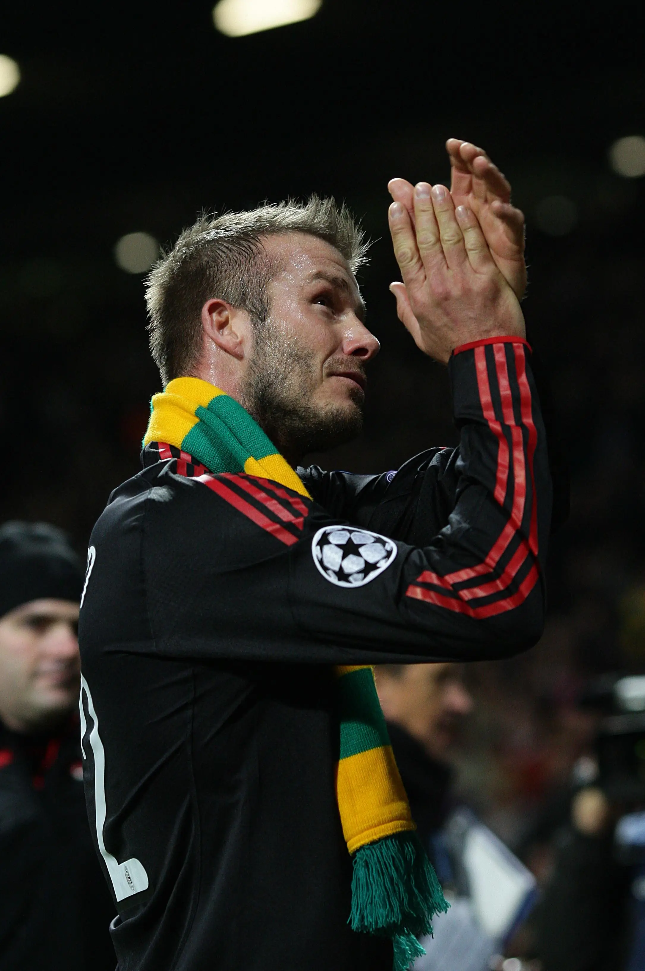 David Beckham wearing a scarf containing the famous 'Green and Gold' colours of the anti-Glazer movement while playing for AC Milan. (Alamy)