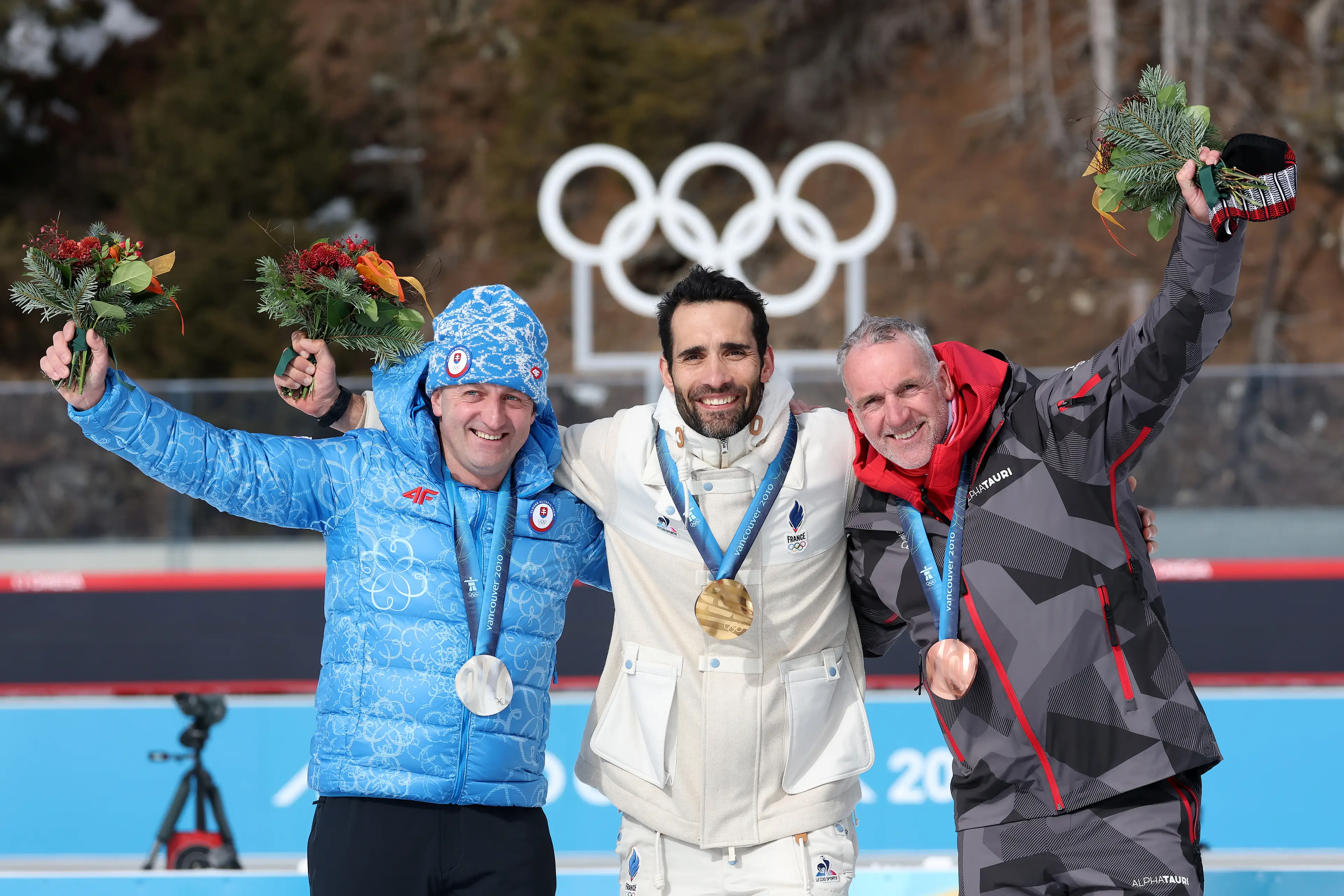 Gold medalist Martin Fourcade of Team France (C), Silver medalist Pavol Hurajt of Team Slovakia (L) and Bronze medalist Christoph Sumann of team Austria (R) pose for a photo during the reallocation ceremony. Image credit: Getty