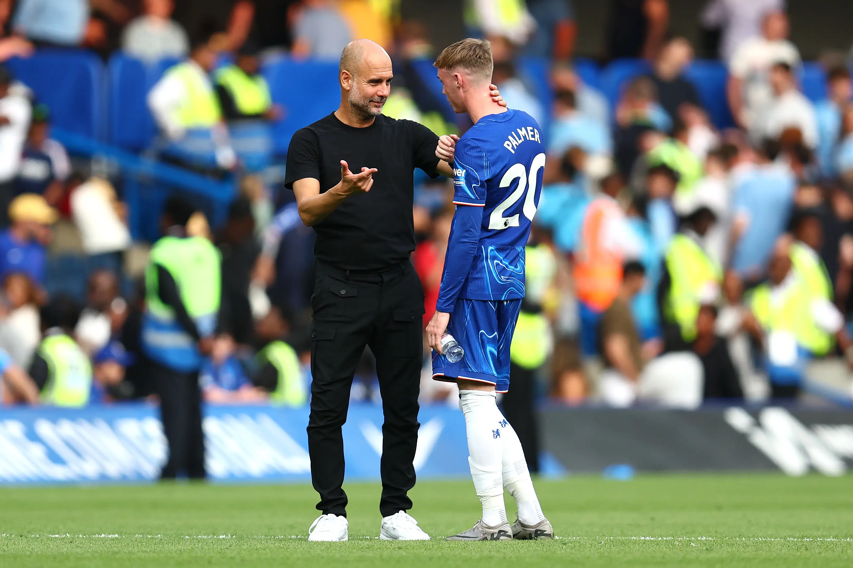 Pep Guardiola speaks to Cole Palmer after Manchester City's victory over Chelsea. Image: Getty 