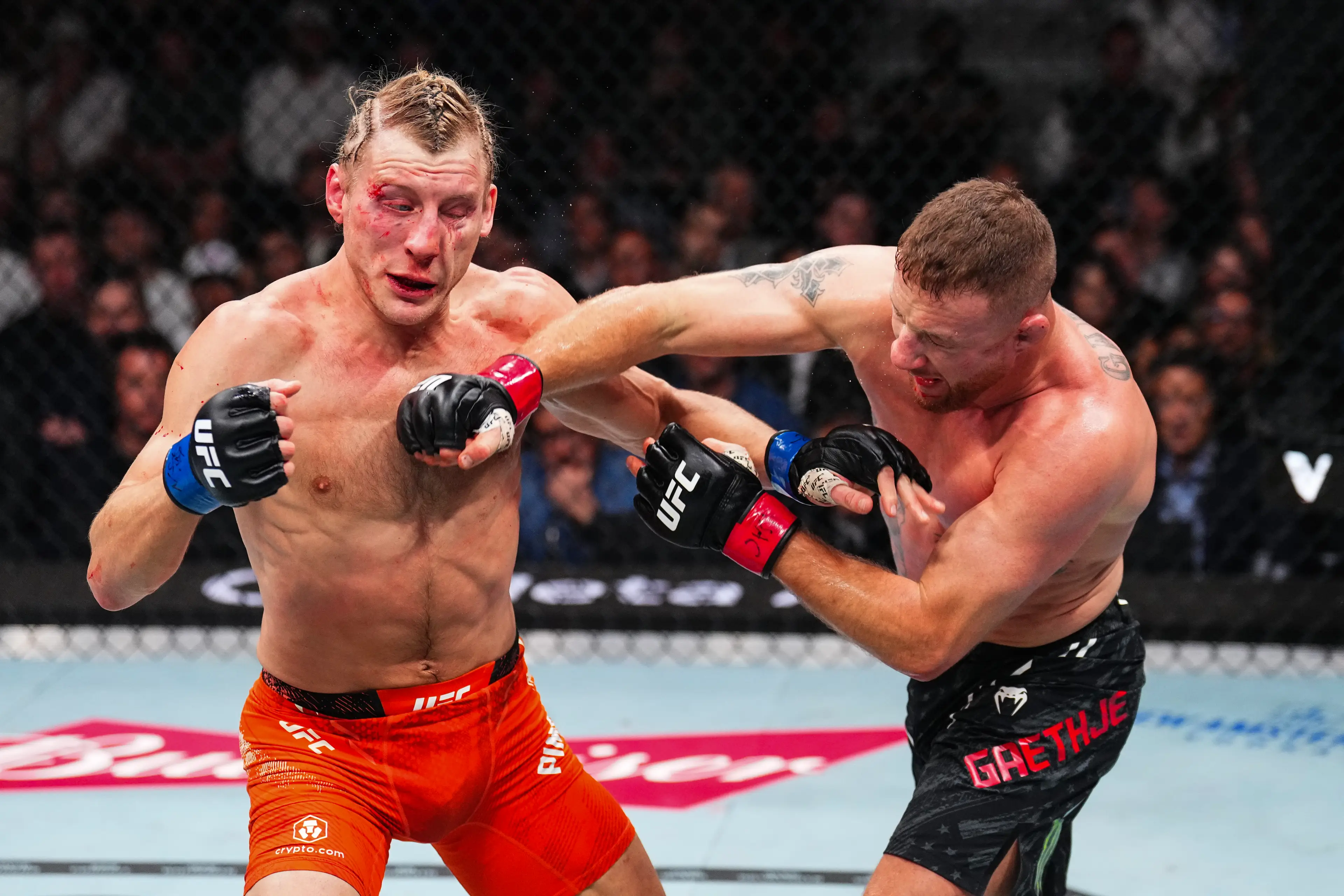 Paddy Pimblett eats a punch from Justin Gaethje during their UFC 324 title fight. Image: Getty 