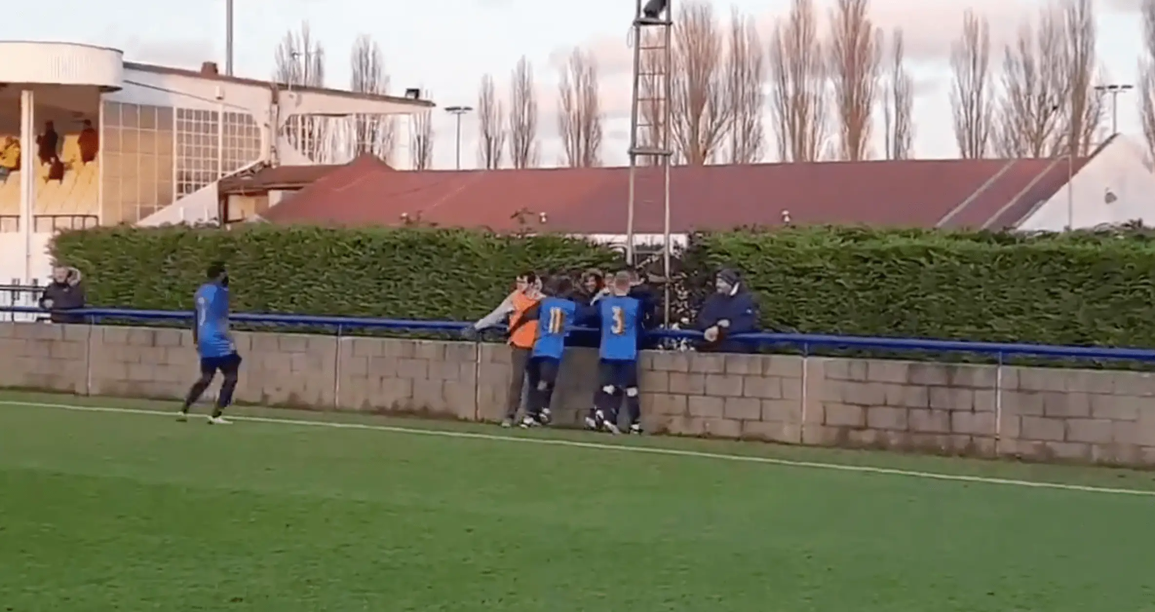 Part of the concrete block in place around the pitch at Wingate & Finchley's stadium (photo from 2020) (Image: Twitter/@WinFinchleyFC)