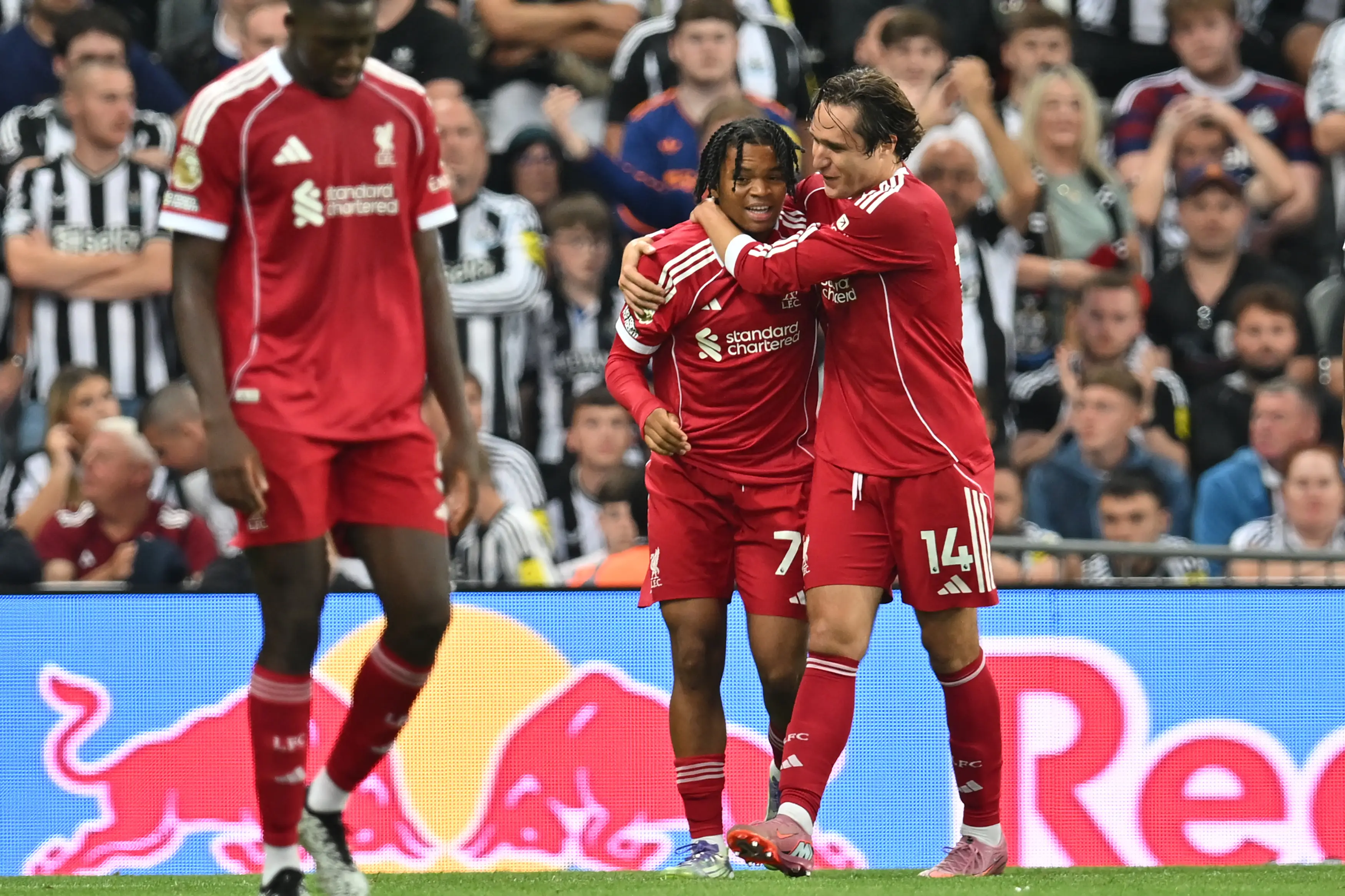 Federico Chiesa celebrates with Rio Ngumoha after the win at Newcastle. (Image: ANDY BUCHANAN / Contributor via Getty)