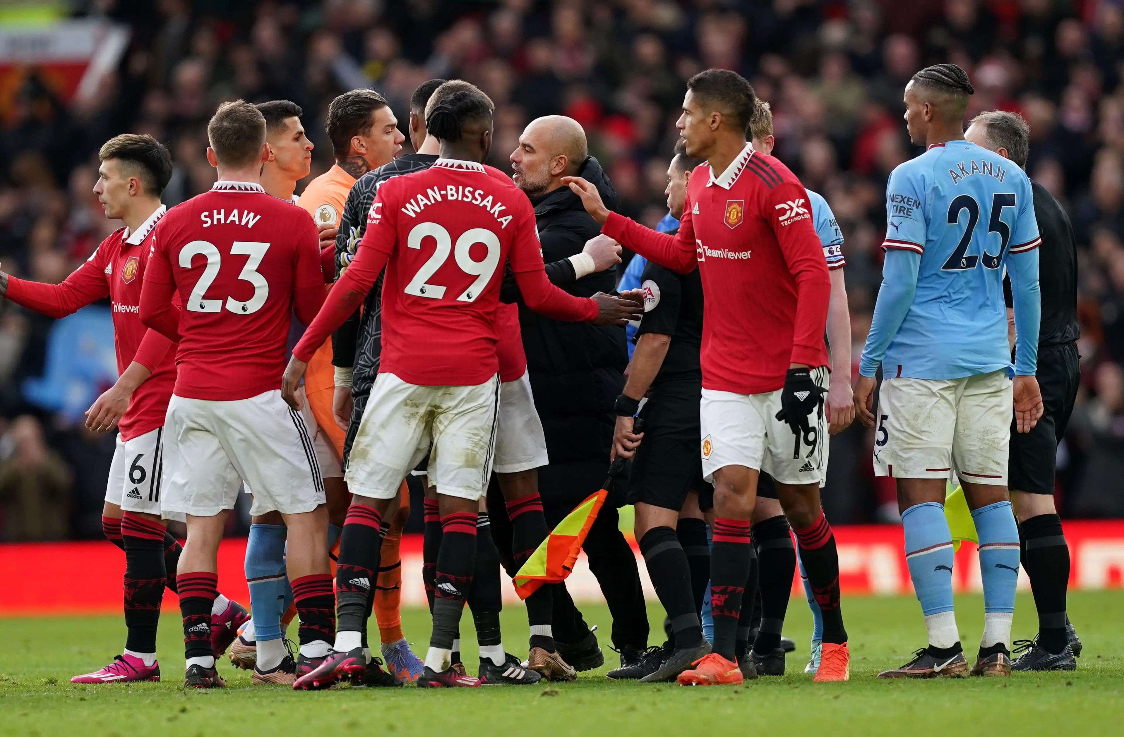 City manager Pep Guardiola in conversation with Stuart Attwell. (Image