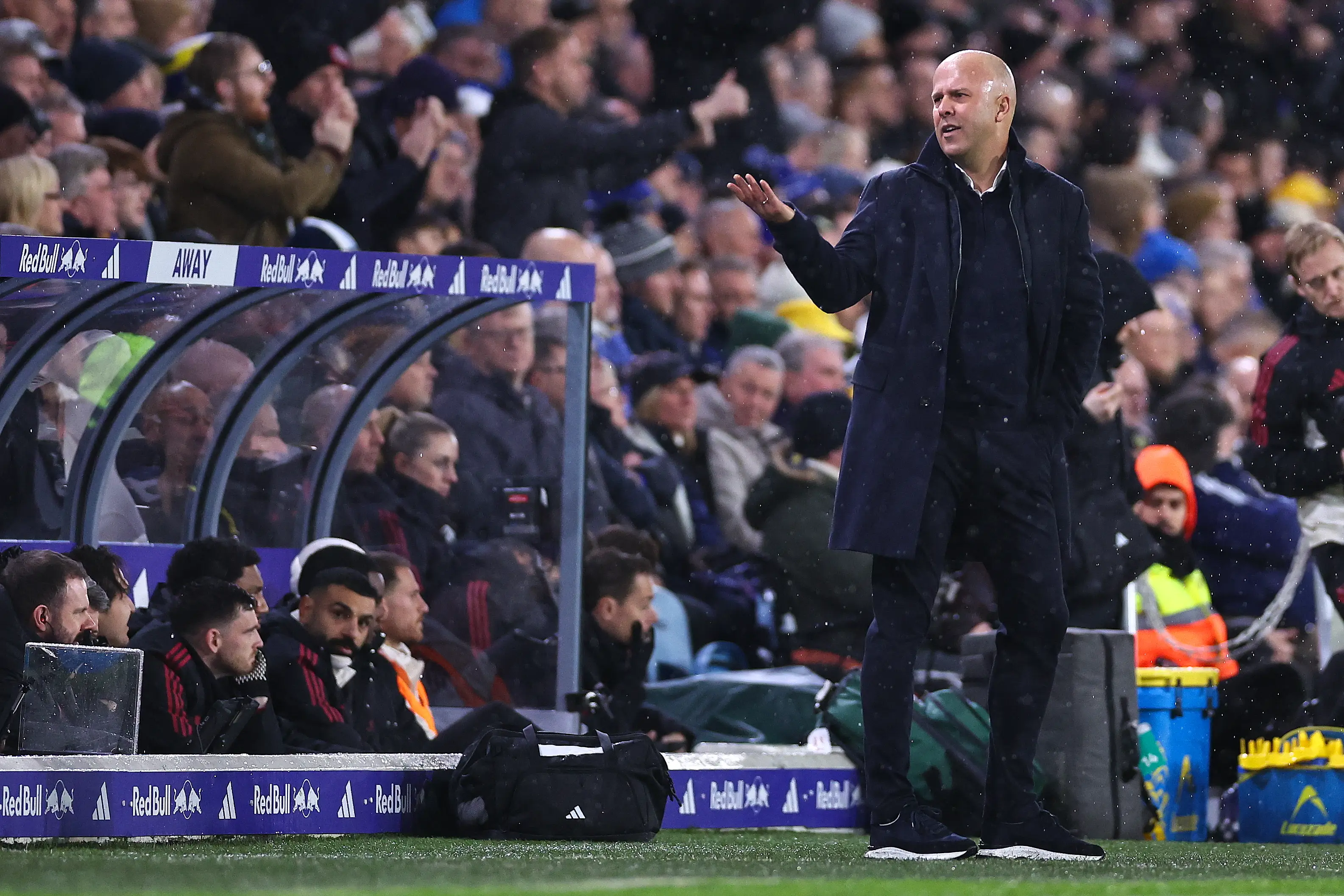Arne Slot watches on at Leeds with Mo Salah on the bench (Image: Getty)