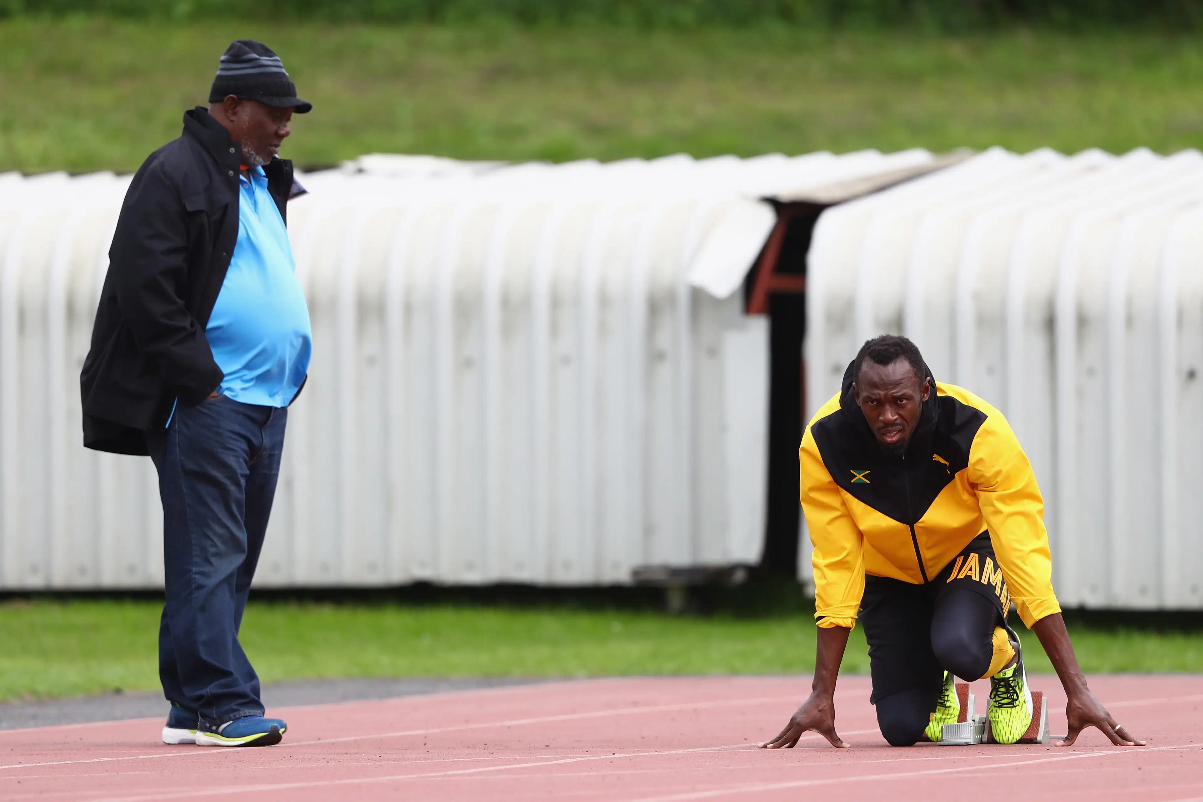 Usain Bolt alongside his coach Glen Mills during a training session ahead of the 16th IAAF World Athletics Championships London in 2017. Image credit: Getty