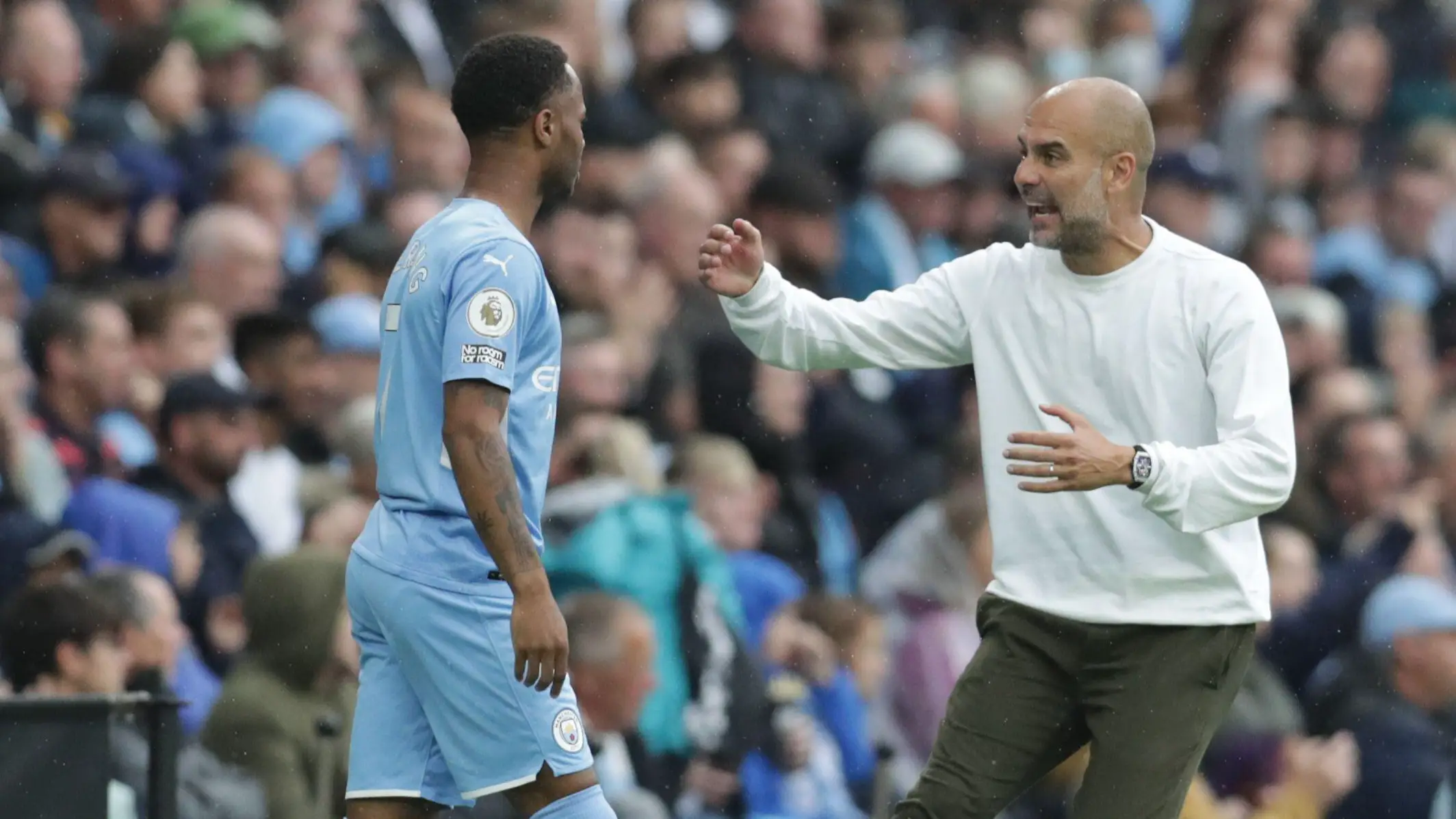 Manchester City manager Pep Guardiola with Raheem Sterling
