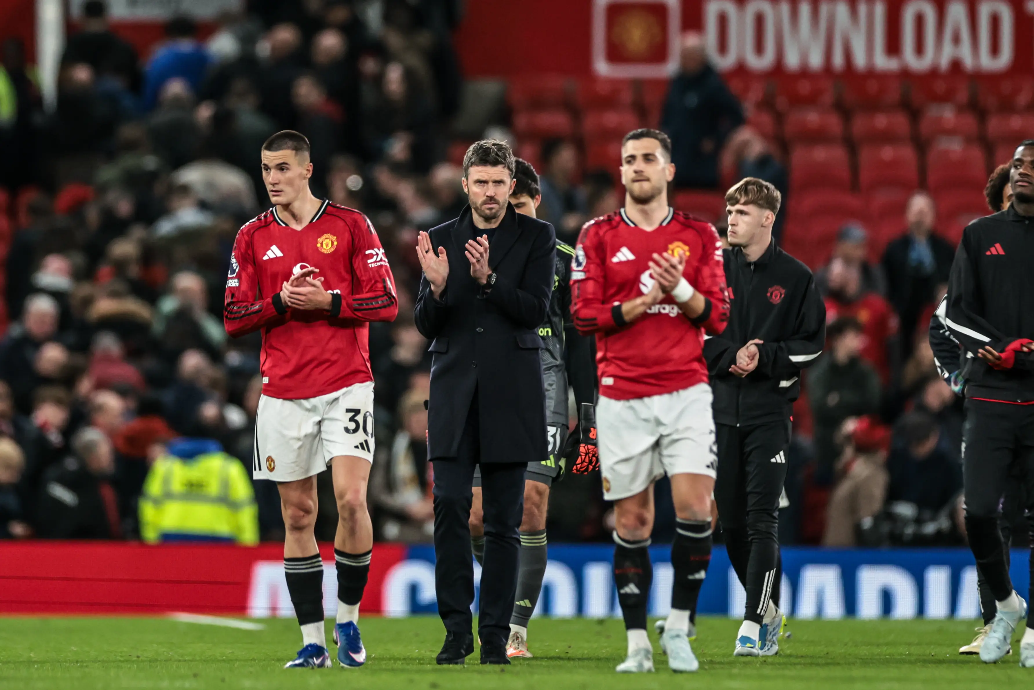 Michael Carrick and his players after defeat to Leeds United (credit: getty)