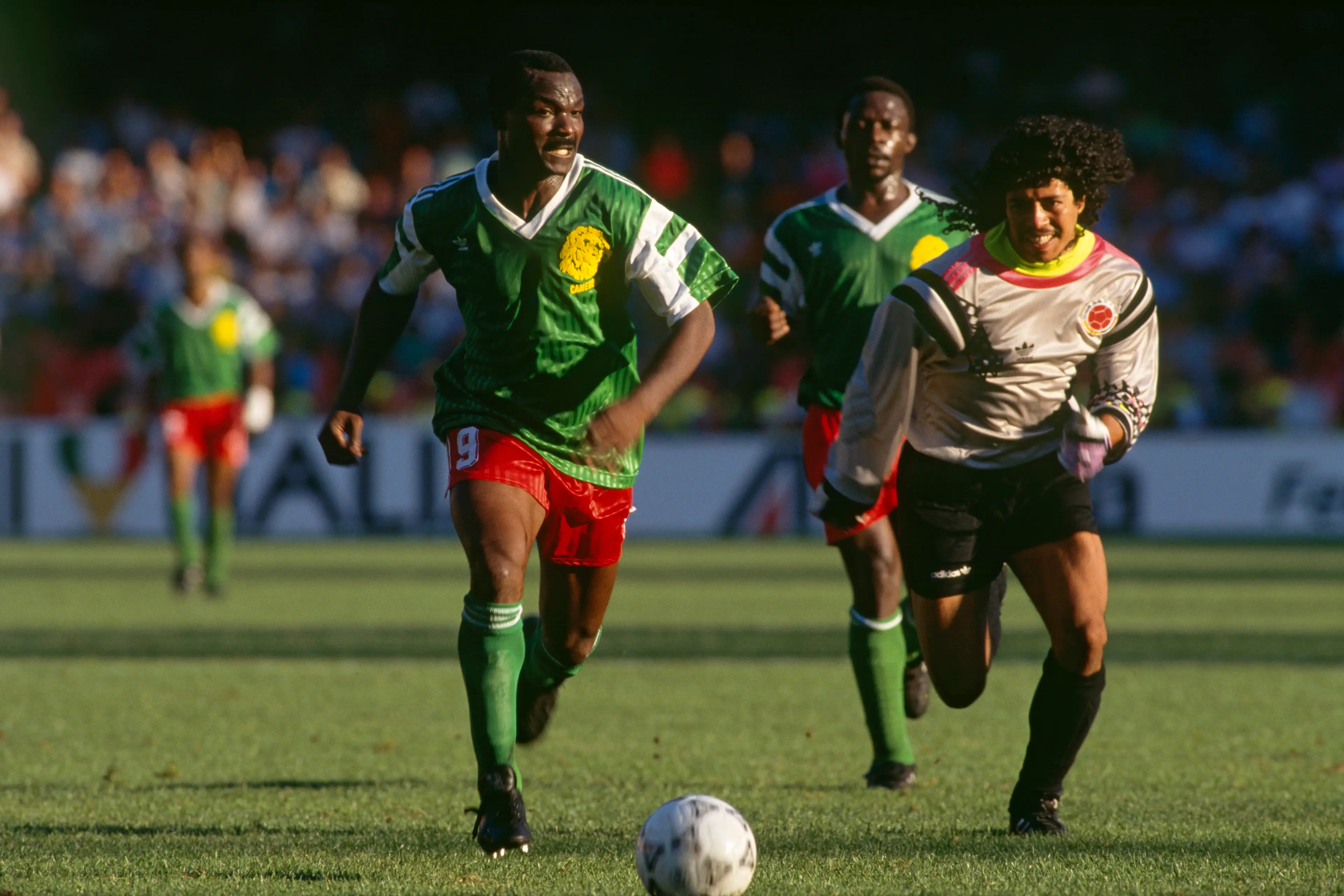 Roger Milla (Cameroon) chases after Rene Higuita (Colombia) on his way to score a goal and put his team through to the quarter-finals of the 1990 FIFA World Cup. (Getty Images)