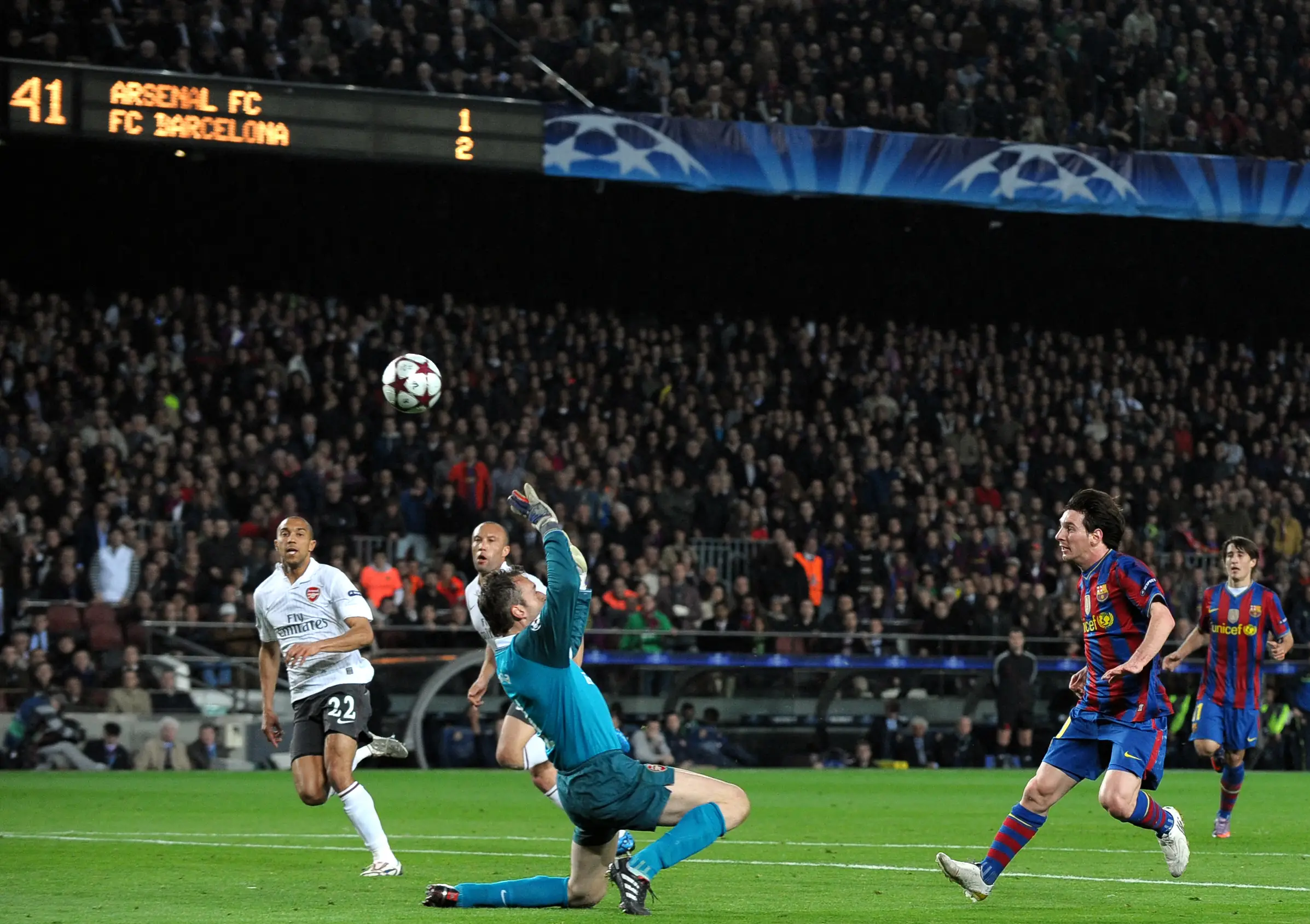 Lionel Messi chips the ball over Manuel Almunia to score his hat-trick. Image credit: Getty