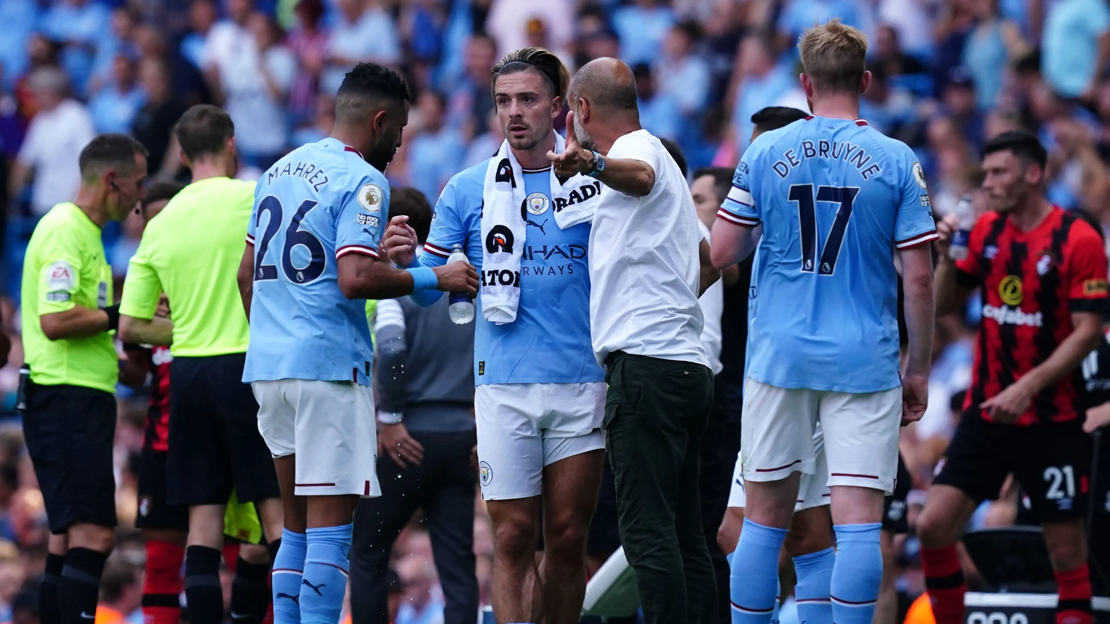 Jack Grealish in a tactical discussion with Pep Guardiola. (PA Images / Alamy)
