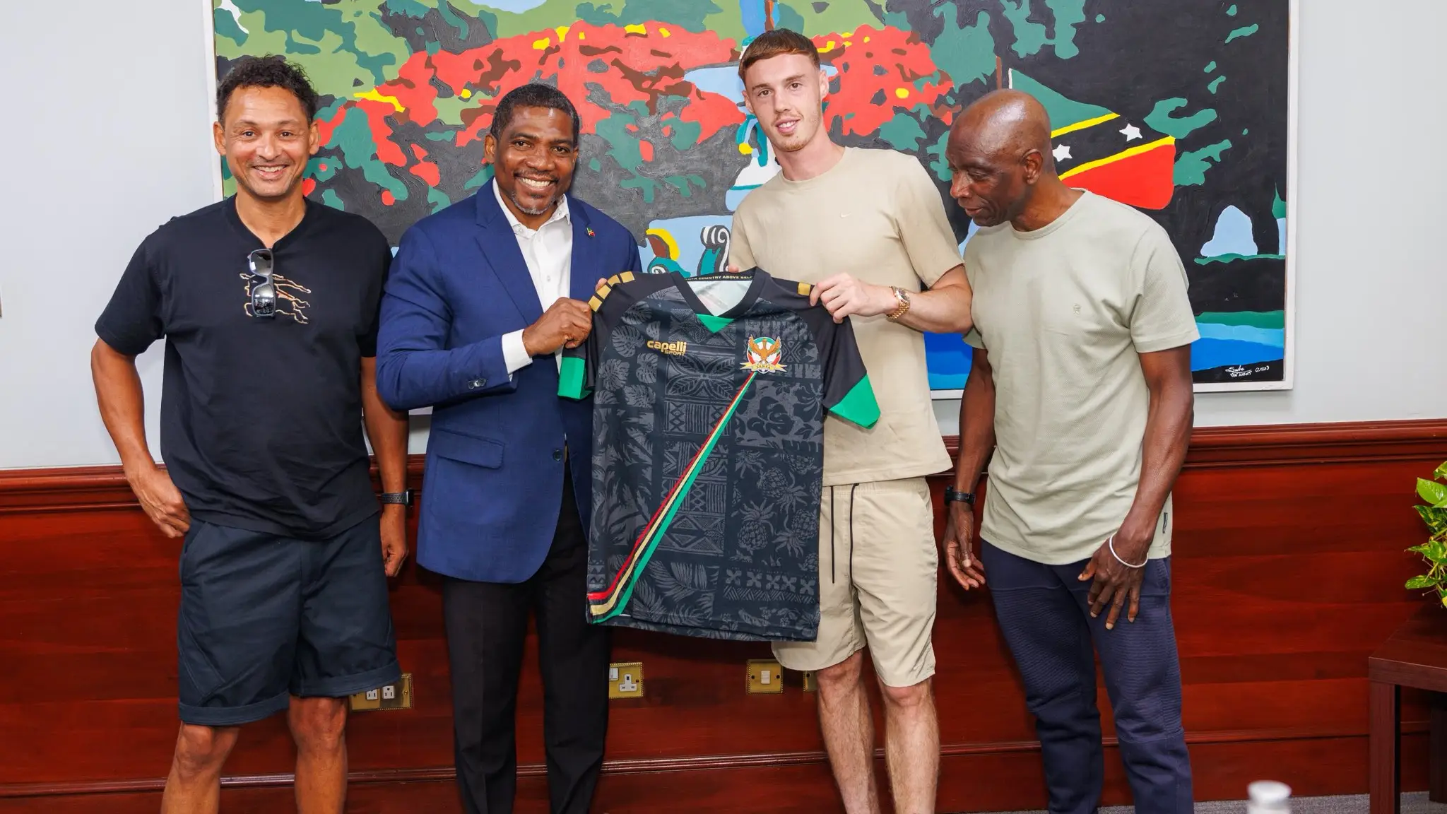 Cole Palmer is presented with the St. Kitts and Nevis national team jersey / Photo by Honourable Dr Terrance Drew/X