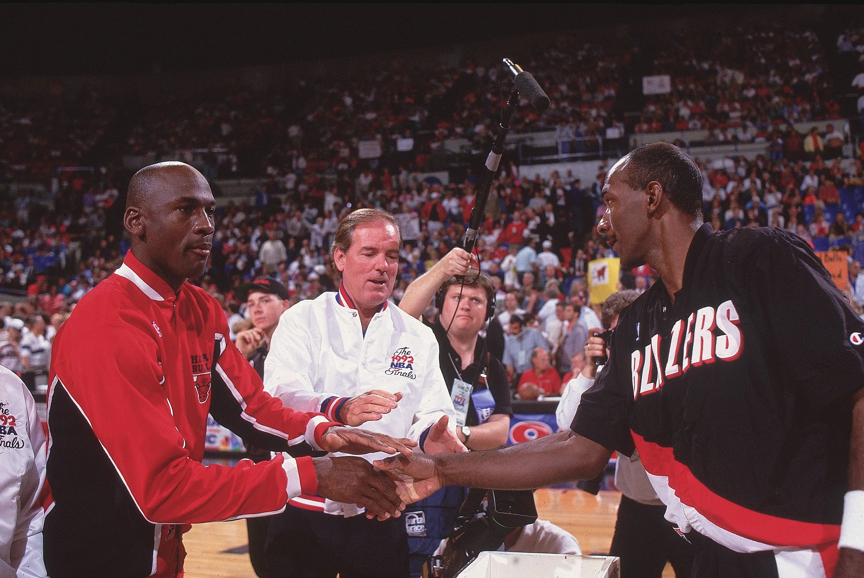 Michael Jordan and Clyde Drexler shake hands