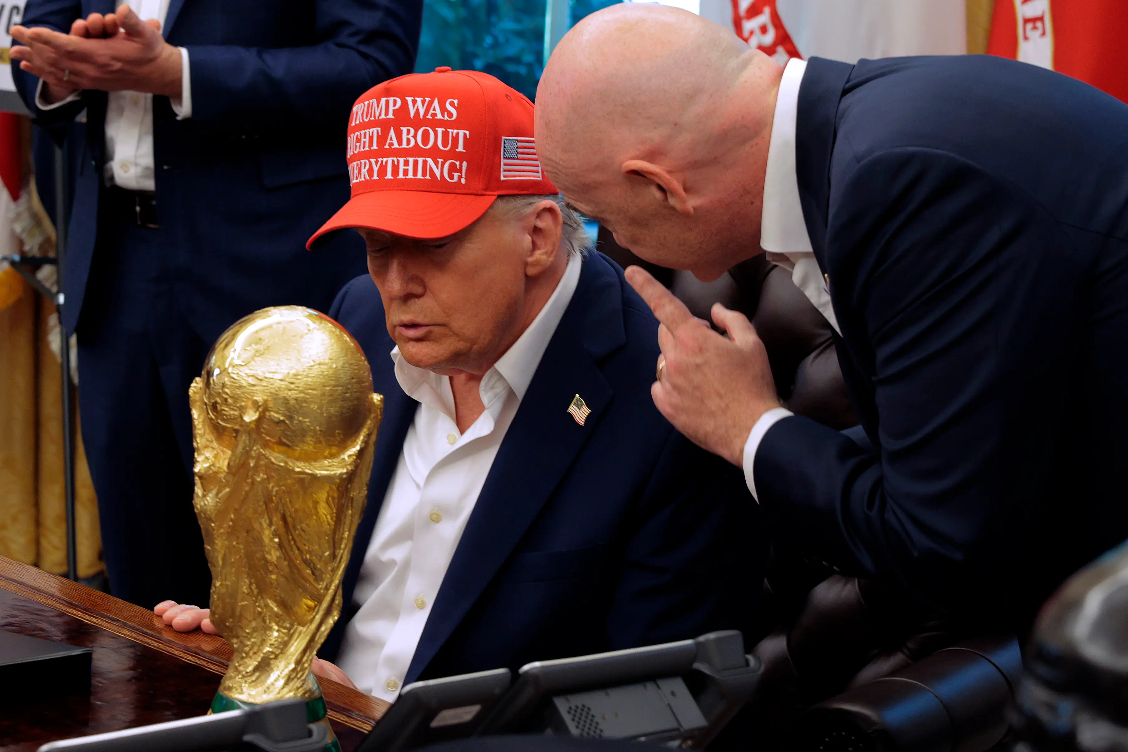 Donald Trump being handed the World Cup by FIFA President Gianni Infantino (credit: getty)