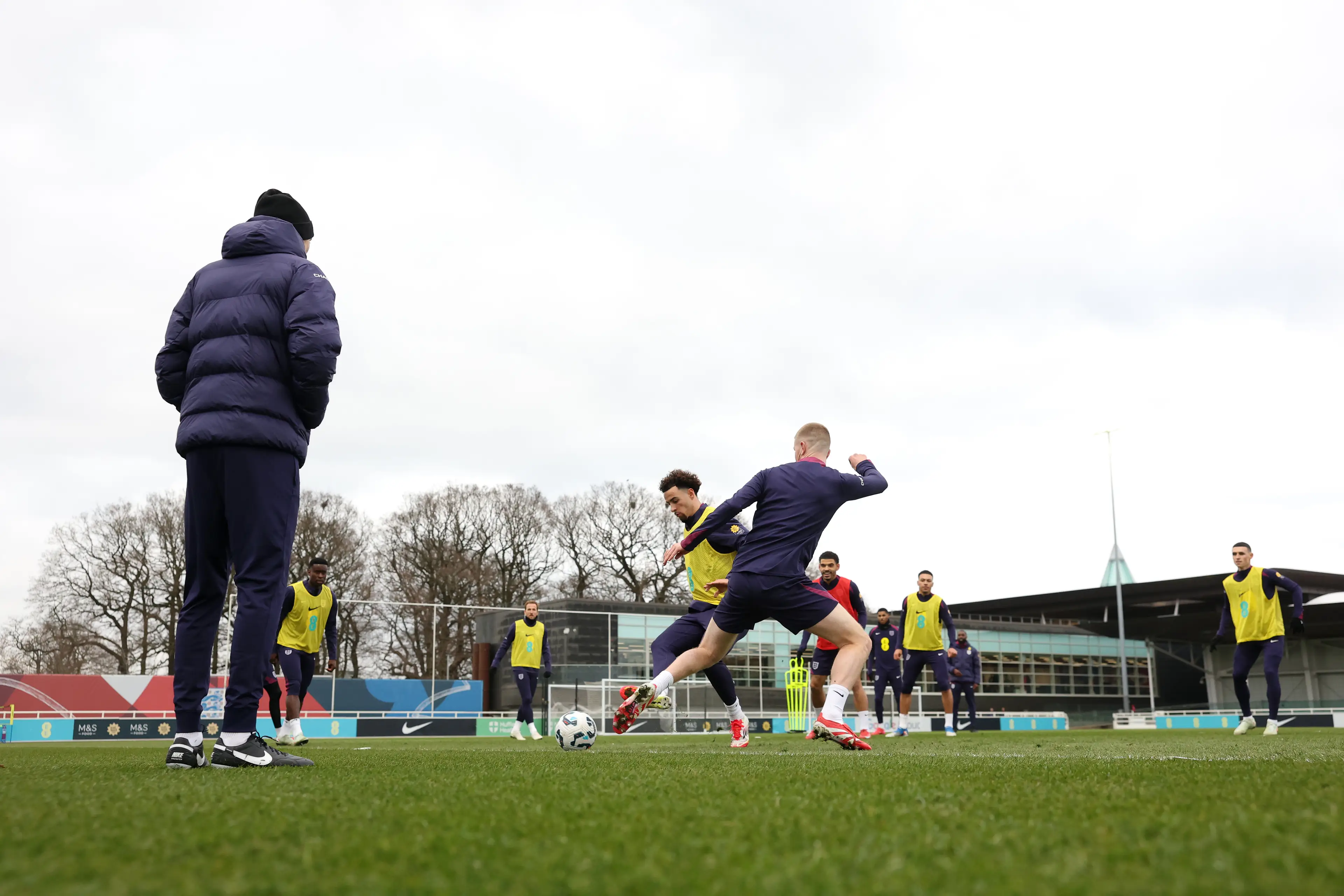 Thomas Tuchel looks on as Adam Wharton trains with the England squad back in March. Image credit: Getty