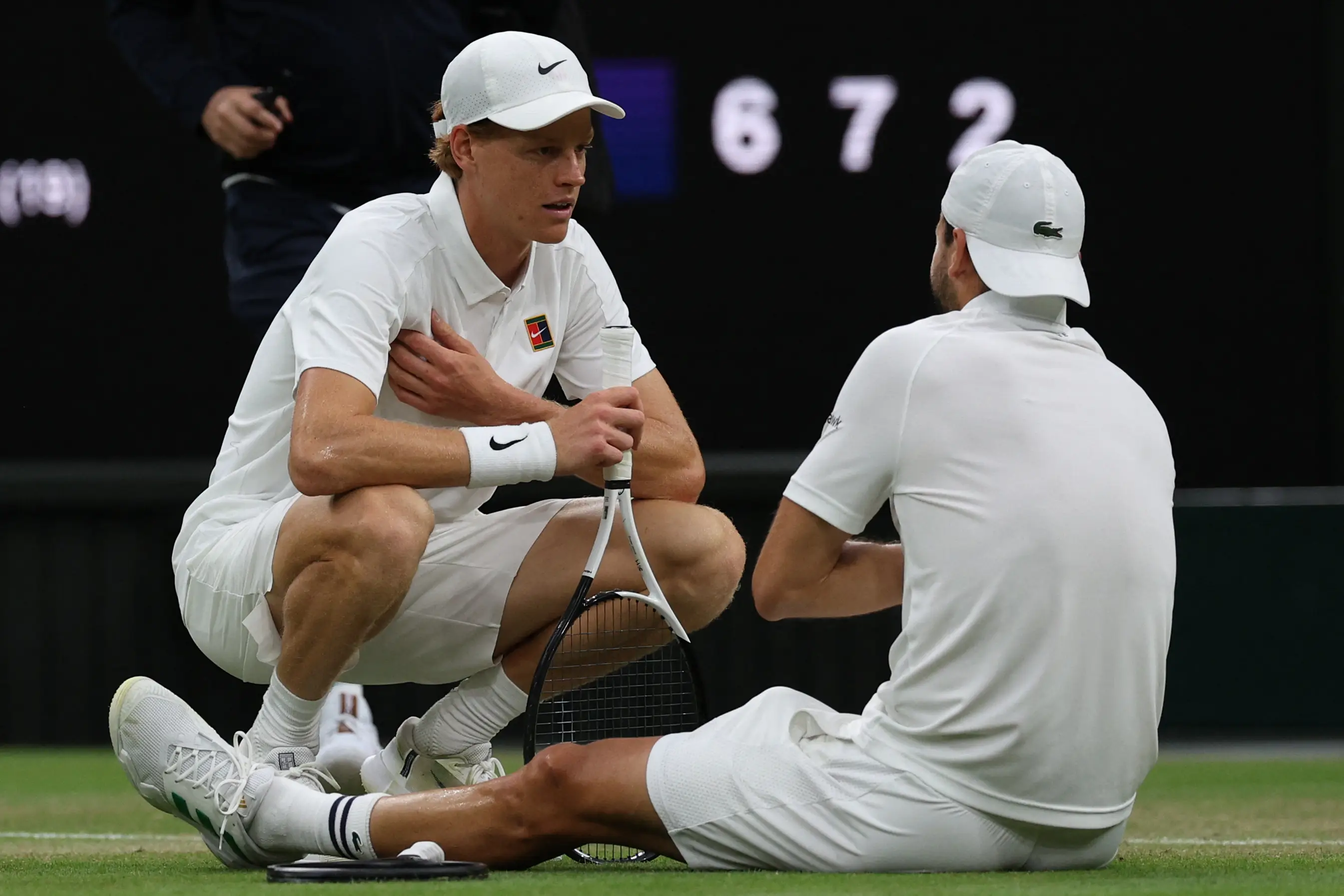 Jannik Sinner consoles Grigor Dimitrov after he suffers an injury. Image: Getty
