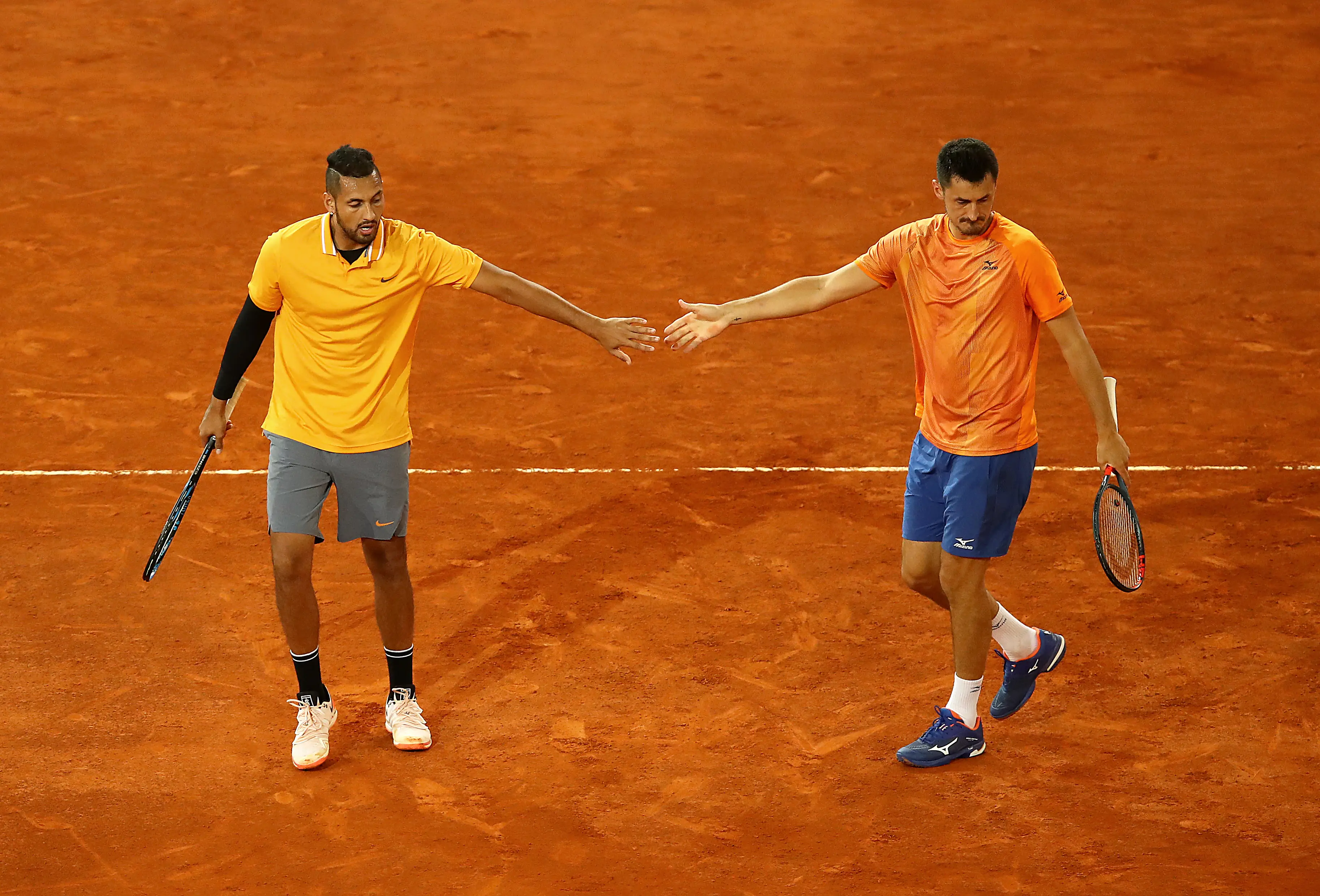 Nick Kyrgios and Tomic in doubles action against John Peers of Australia and Henri Kontinen of Finland during day four of the Mutua Madrid Open in 2019. Image credit: Getty 