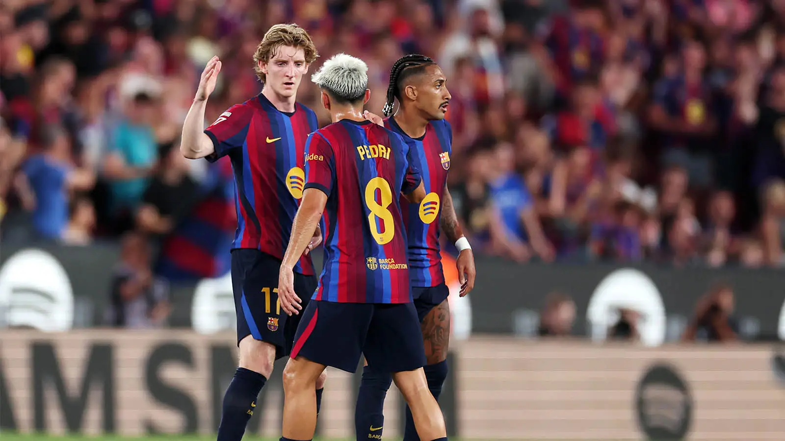 Anthony Gordon pictured with Barcelona team-mates Pedri and Raphinha (Image: Getty)