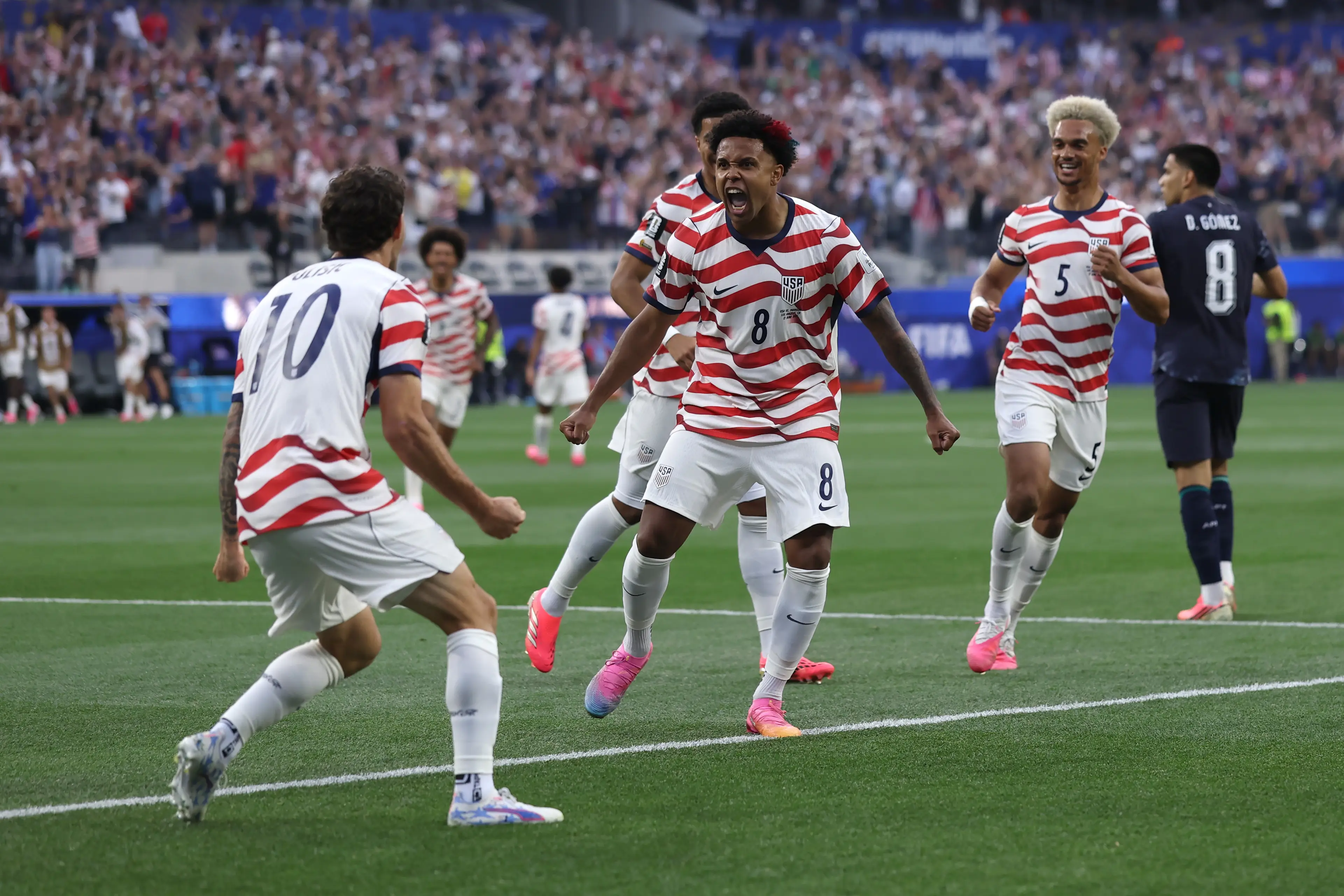 Christian Pulisic #10 and Weston McKennie #8 of the United States celebrate their side's first goal, an own goal by Damian Bobadilla #16 of Paraguay (Getty Images)