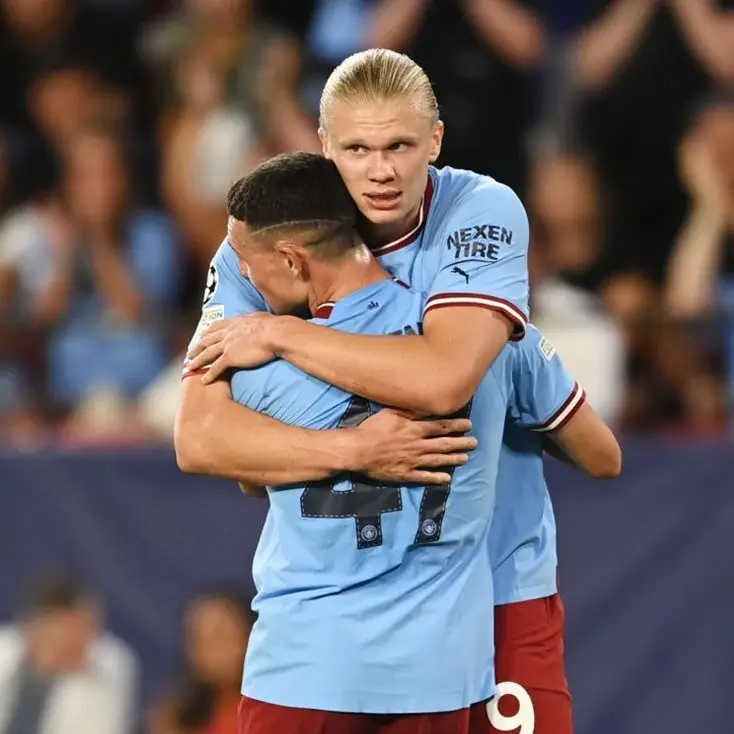 Erling Haaland embraces Phil Foden after scoring his second against Sevilla (Alamy)