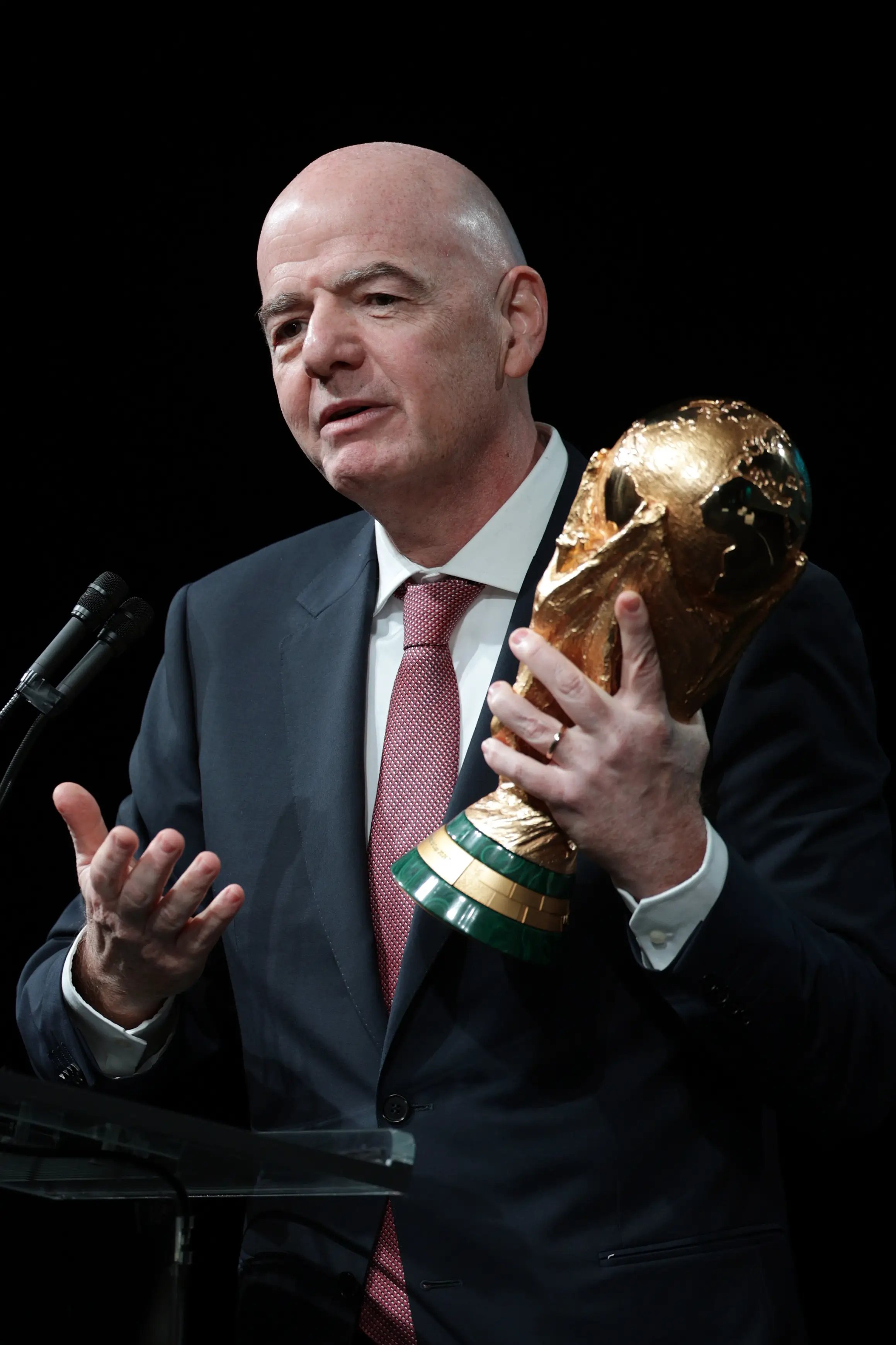 Gianni Infantino holds the World Cup. Image: Getty