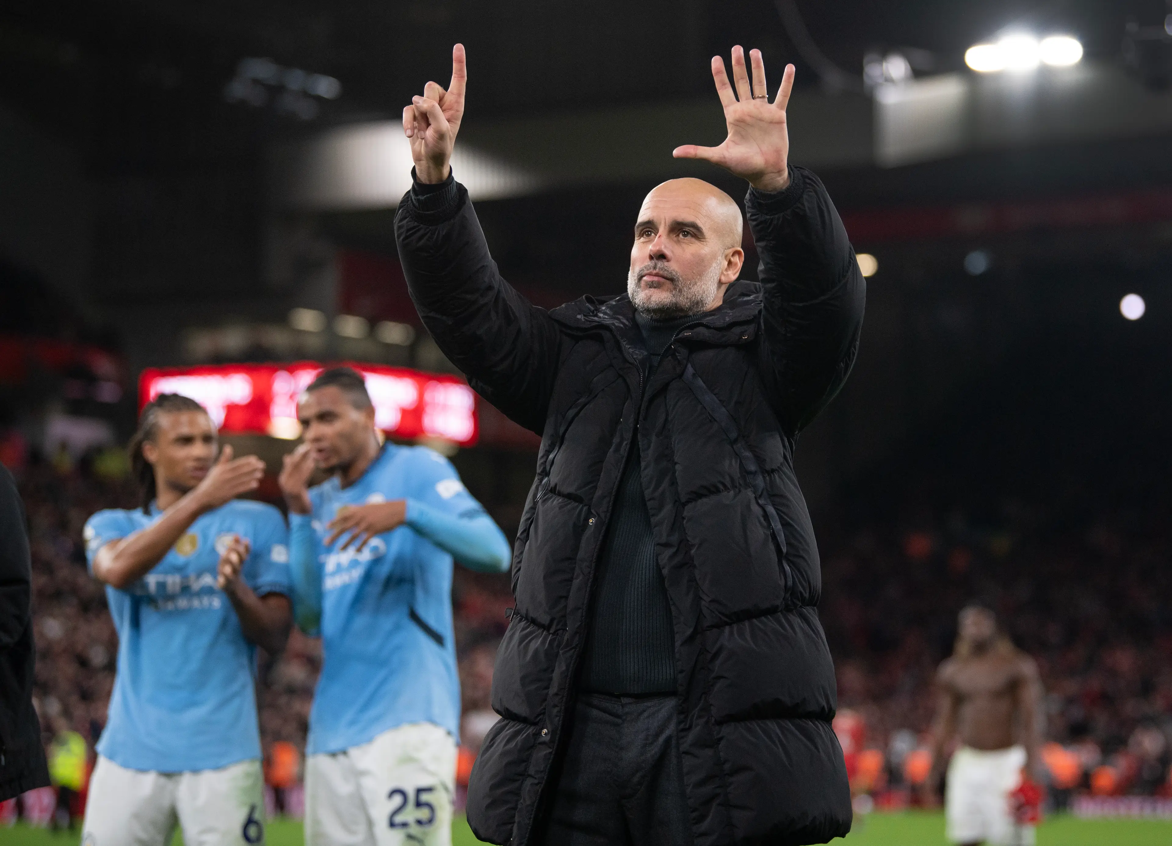 Pep Guardiola holds up six fingers to Manchester City fans indicating the number of Premier League titles he has won following their defeat to Liverpool. Image: Getty 