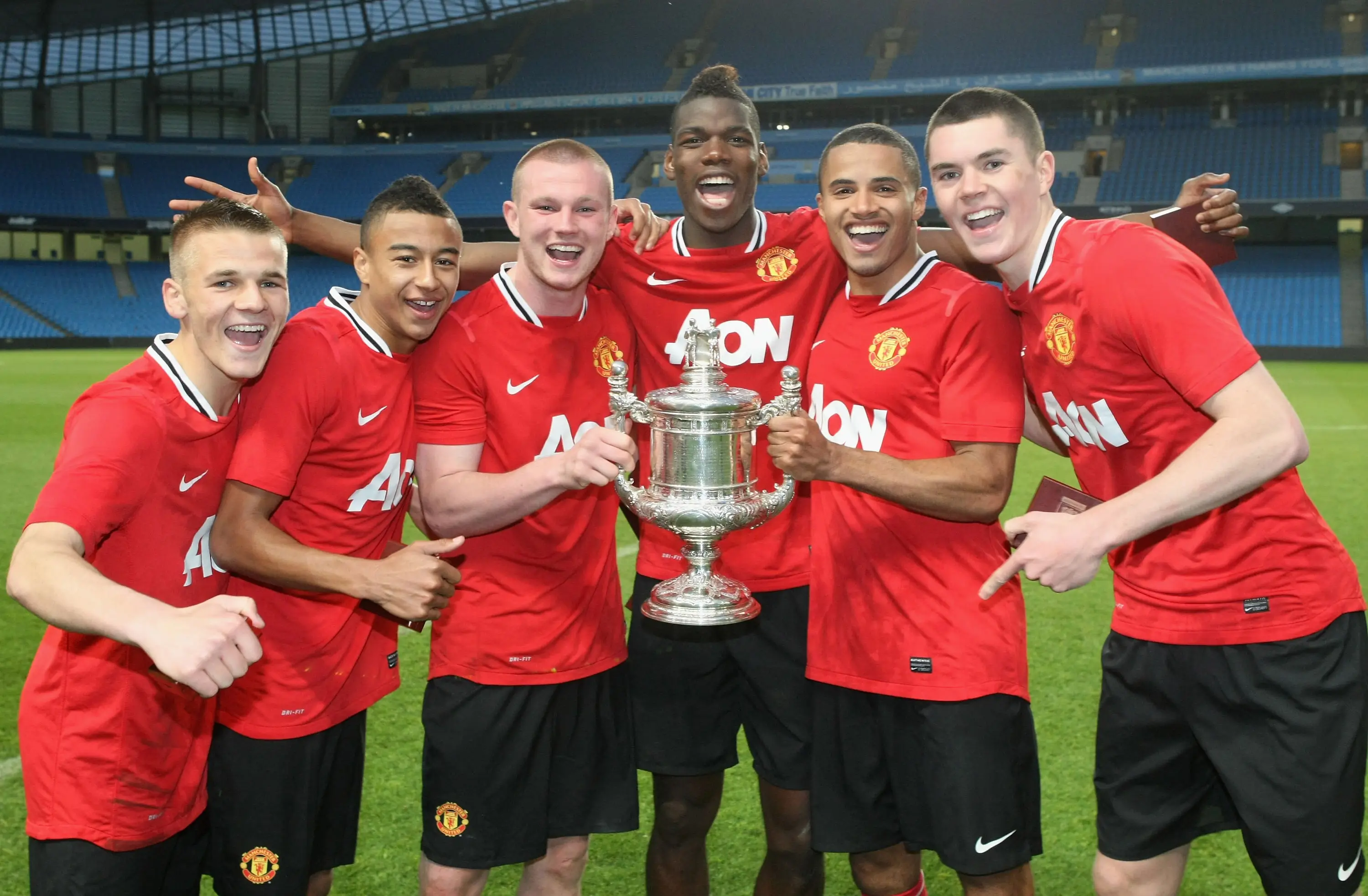 Fryers (second right) celebrates winning Manchester Senior Cup. Image credit: Getty