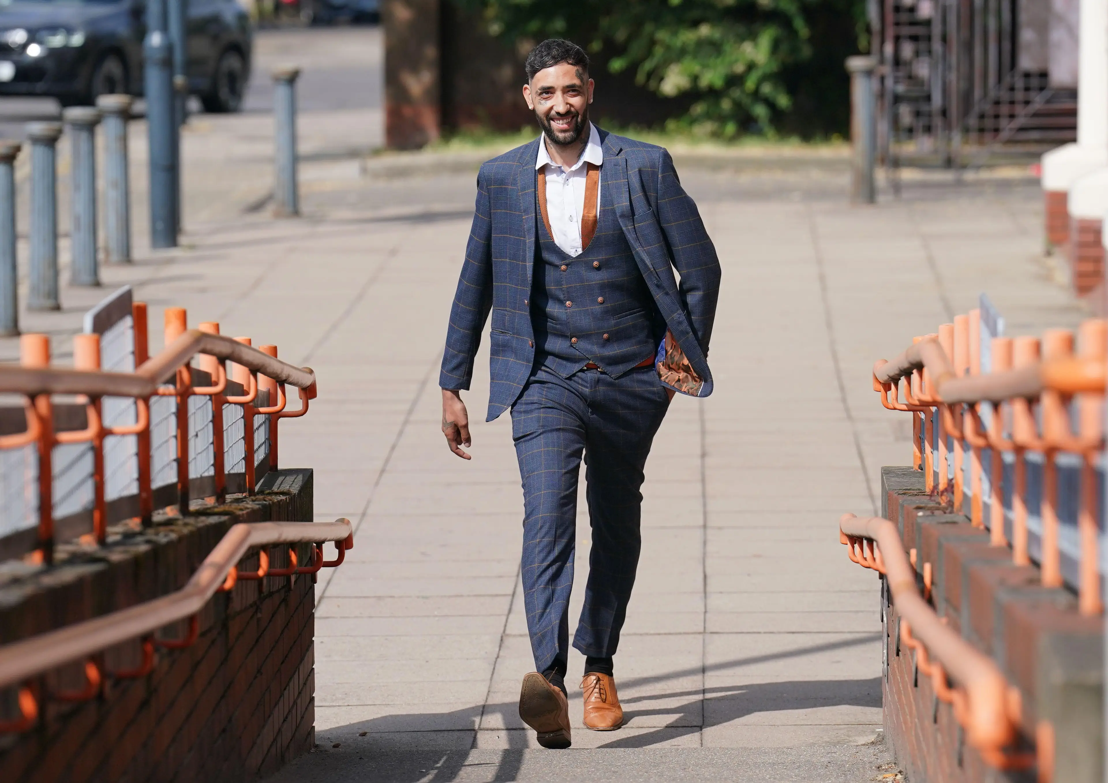 White arrives to court smiling. Image: Alamy