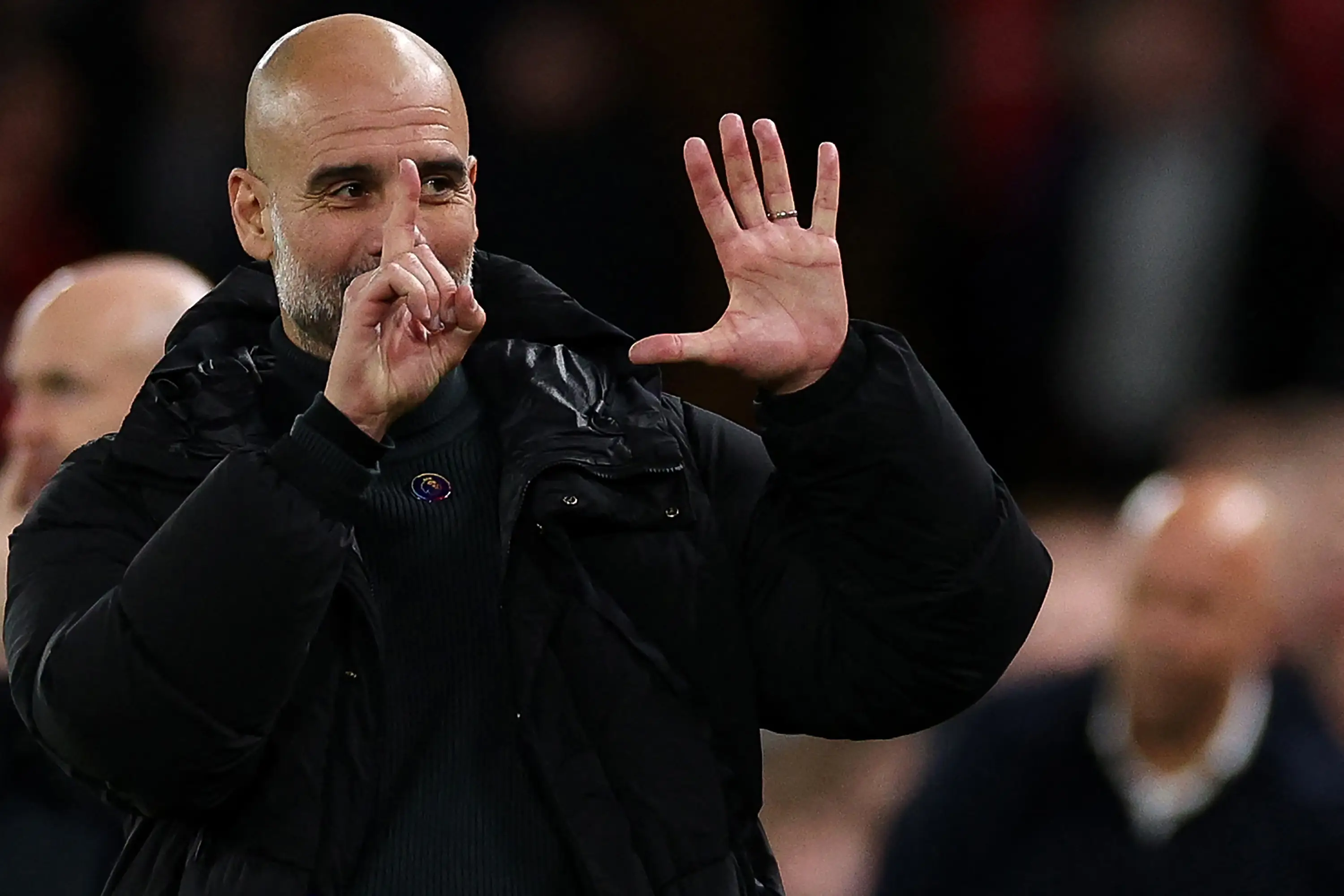 Pep Guardiola displayed six fingers in a gesture to Liverpool fans. Image: Getty