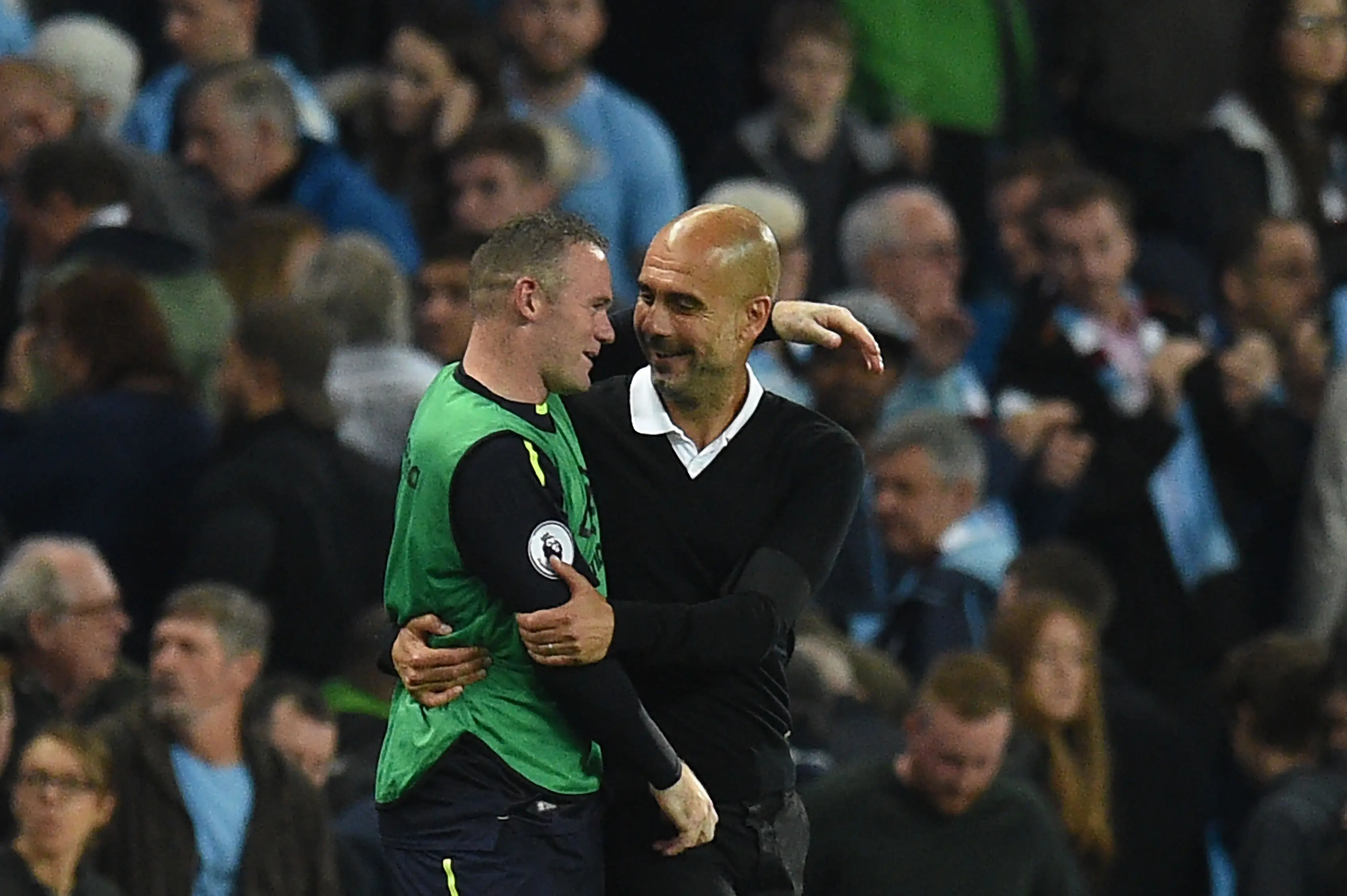 Wayne Rooney and Pep Guardiola share a warm embrace during a Premier League match between Manchester City and Everton. Image: Getty