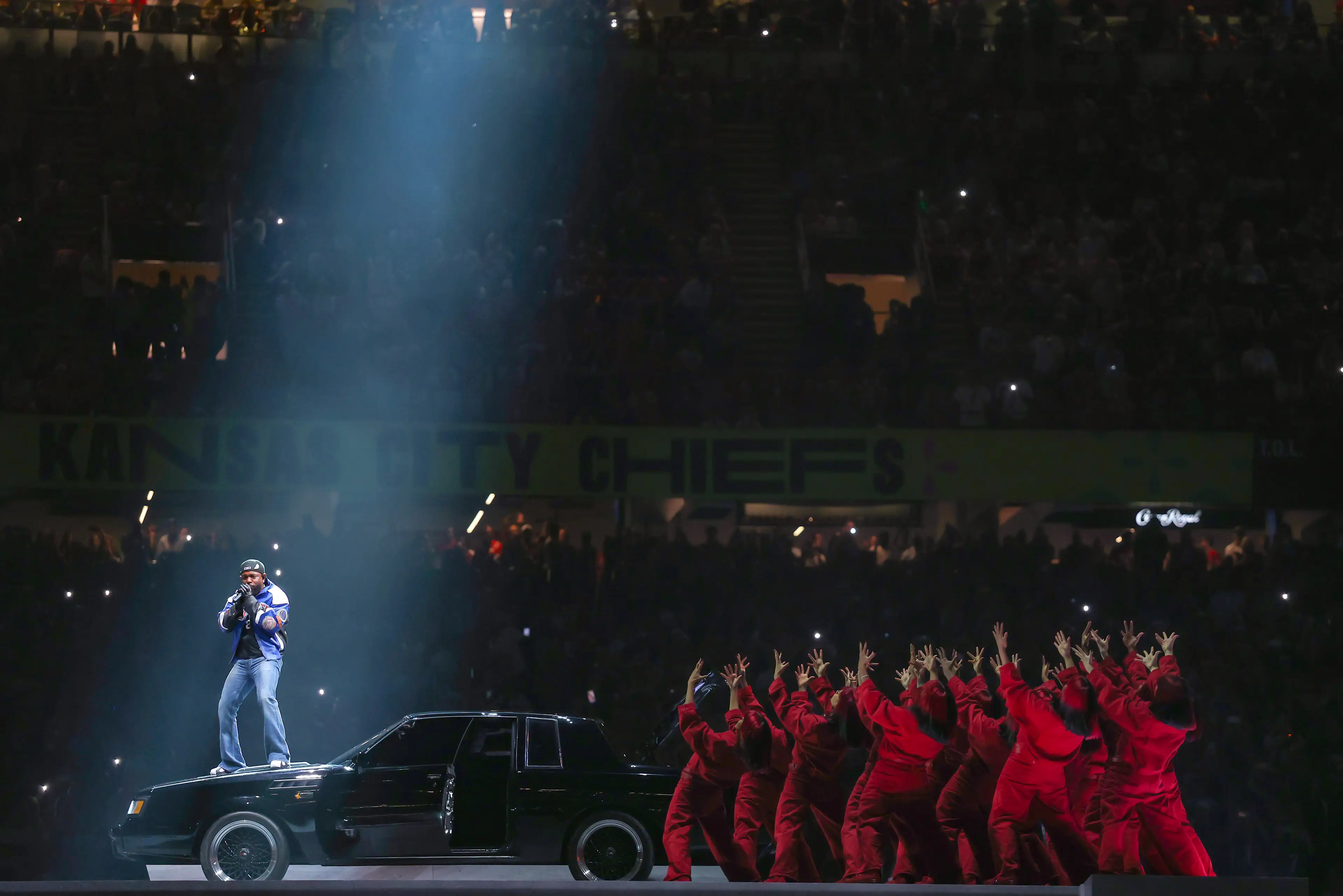 A section of Lamar's performance saw him stand on the hood of a car (Image: Getty)