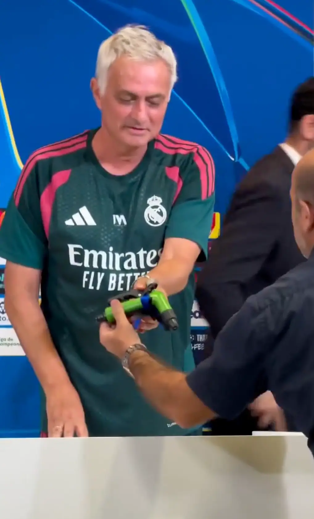 Jose Mourinho is handed a garden sprinkler. Image credit: X