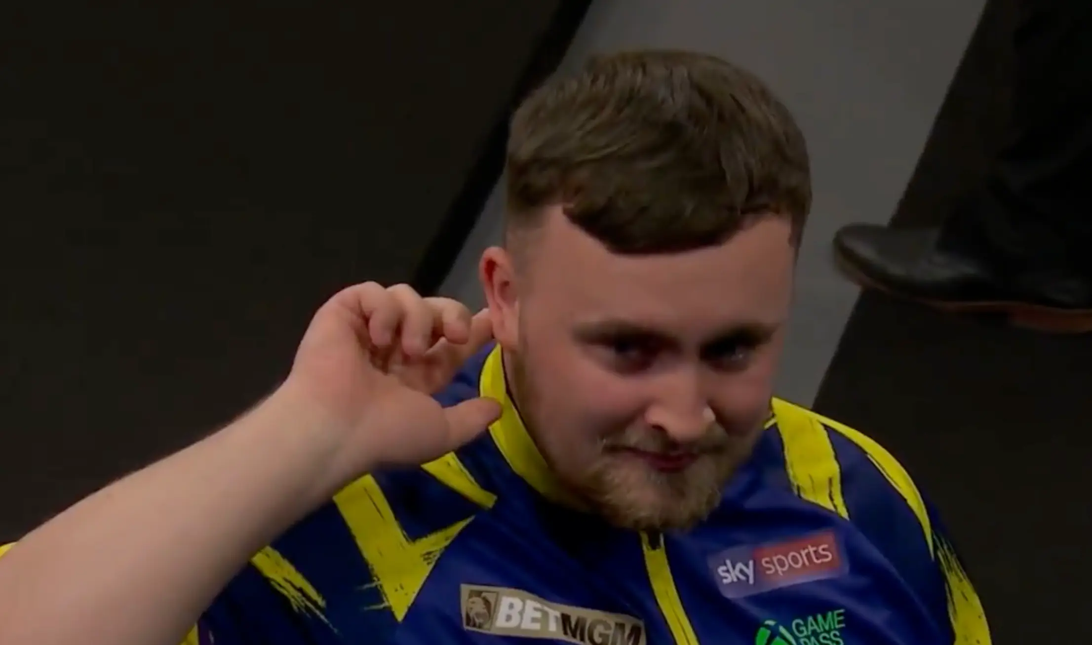Luke Littler reacts to being booed by Brighton crowd. Image credit: Sky Sports