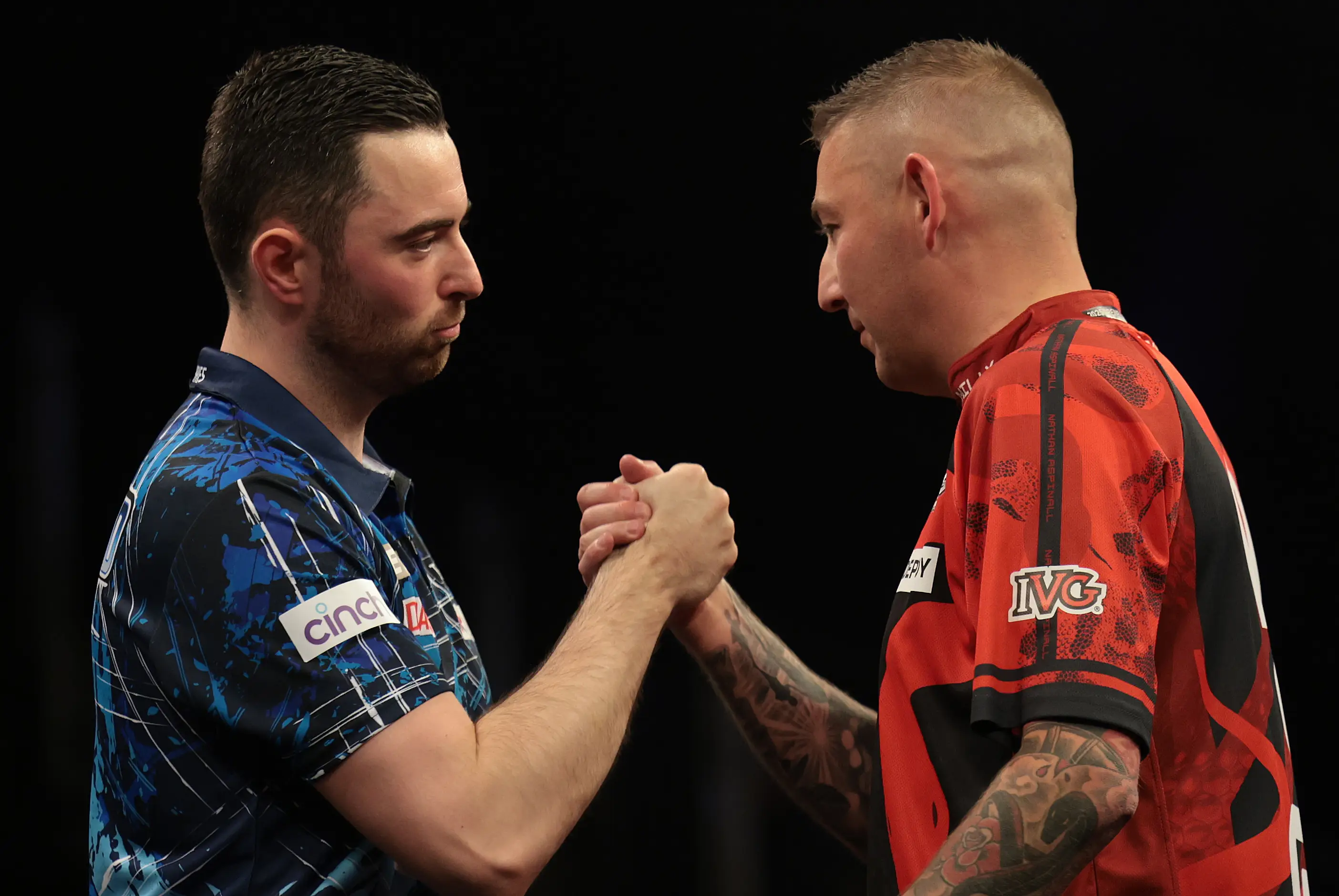 Luke Humphries and Nathan Aspinall share an embrace after their play-off match at the 2025 Premier League Darts Finals Night. Image: Getty
