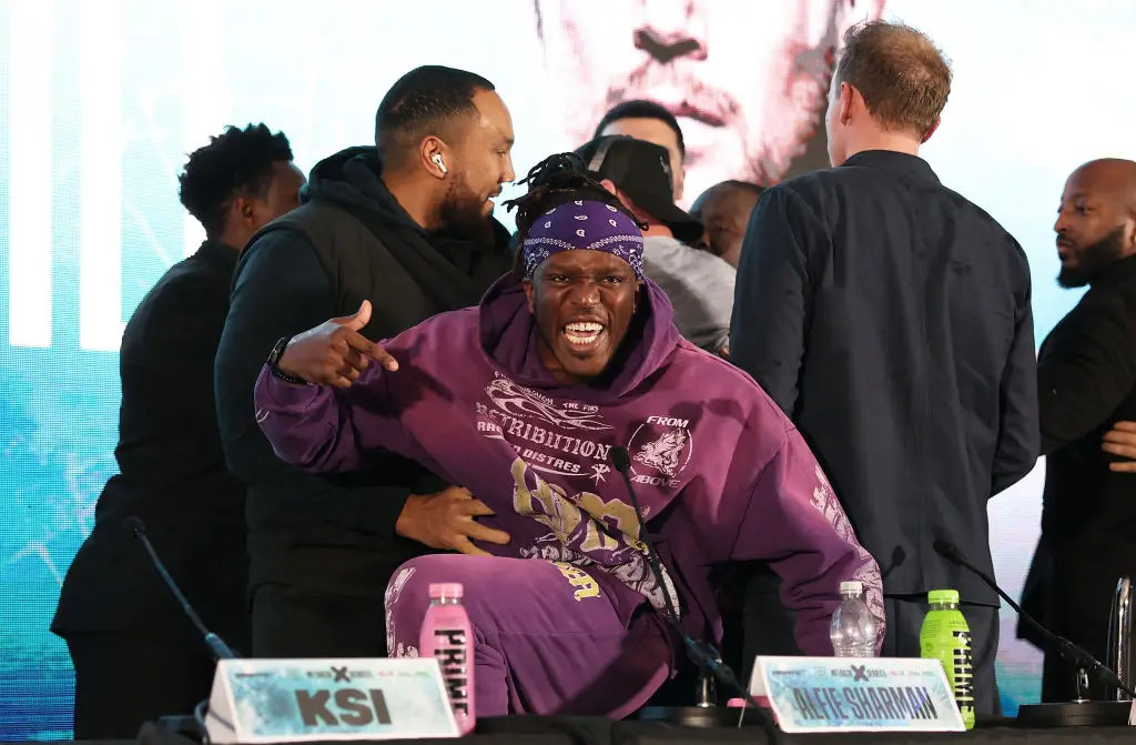 KSI had to be held off as tempers flared during the press conference for Tommy Fury v Darren Till. (Image: Getty)