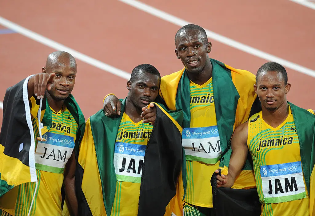 Usain Bolt and Jamaica team-mates Asafa Powell, Nesta Carter and Michael Frater celebrating winning 4x100m relay gold at the Beijing 2008 Olympics (
