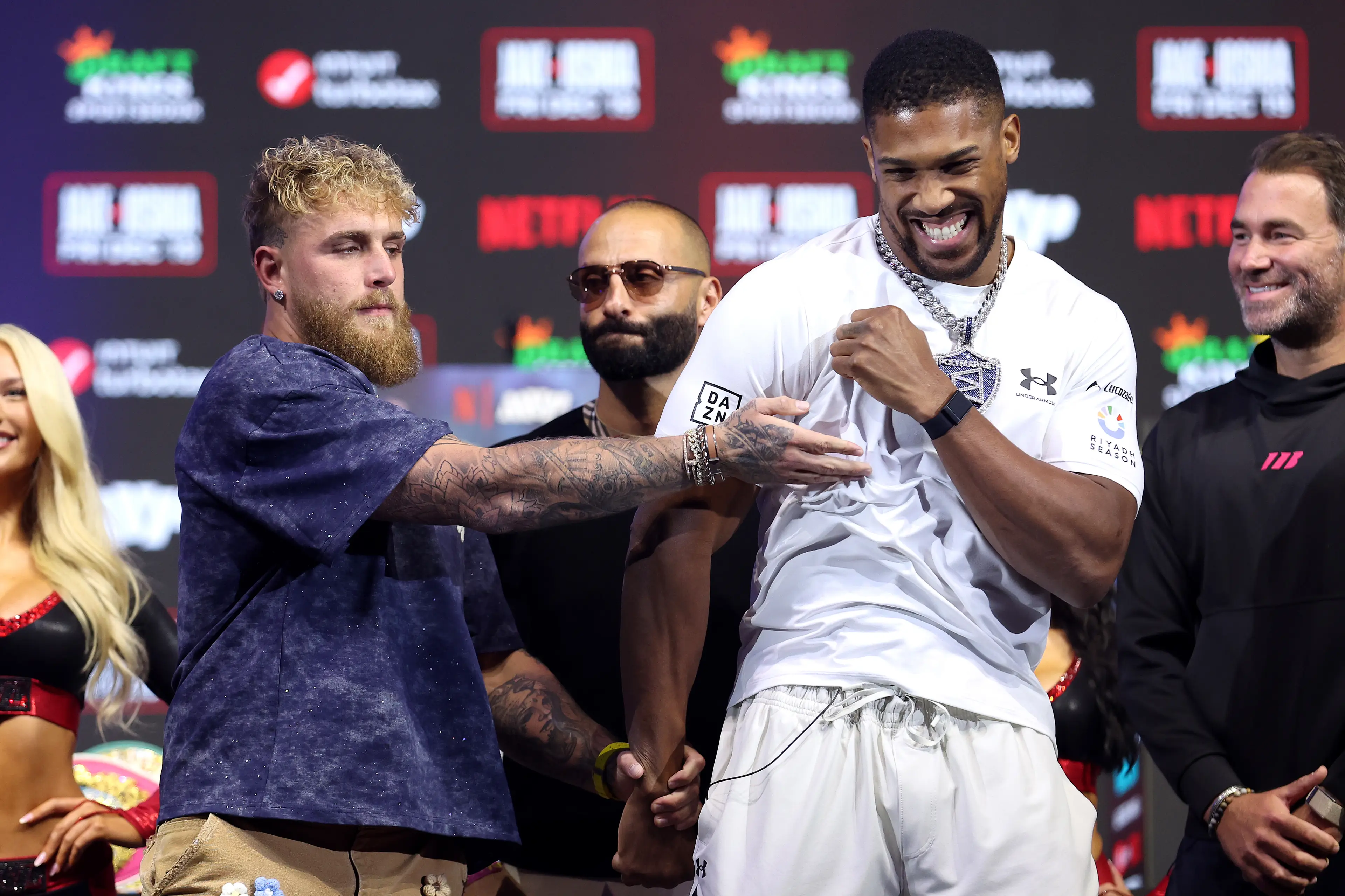 Jake Paul has a playful face-off with Anthony Joshua at their pre-fight press conference. Image: Getty 