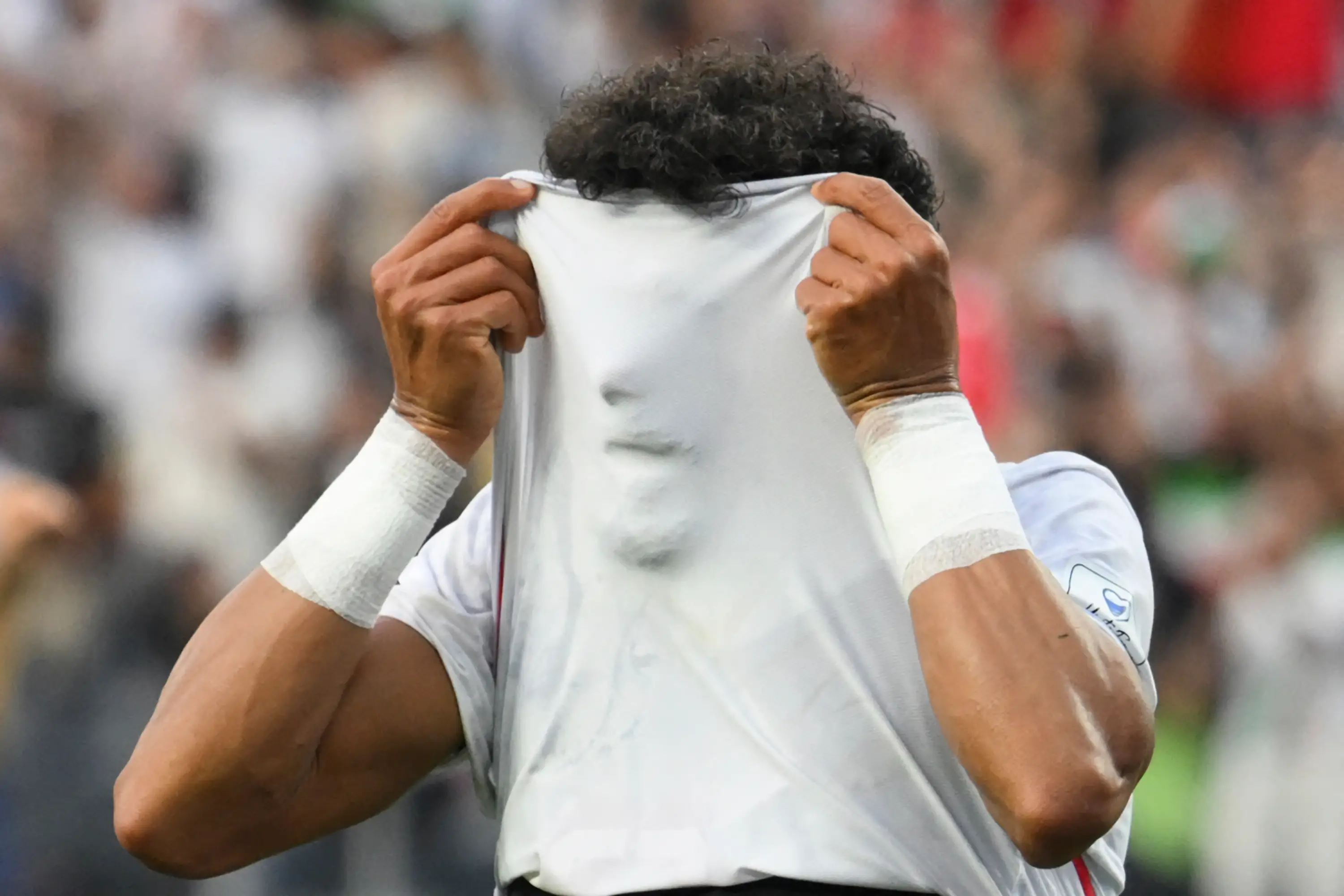 Rezaeian celebrated by pulling his shirt over his face. Image: Getty
