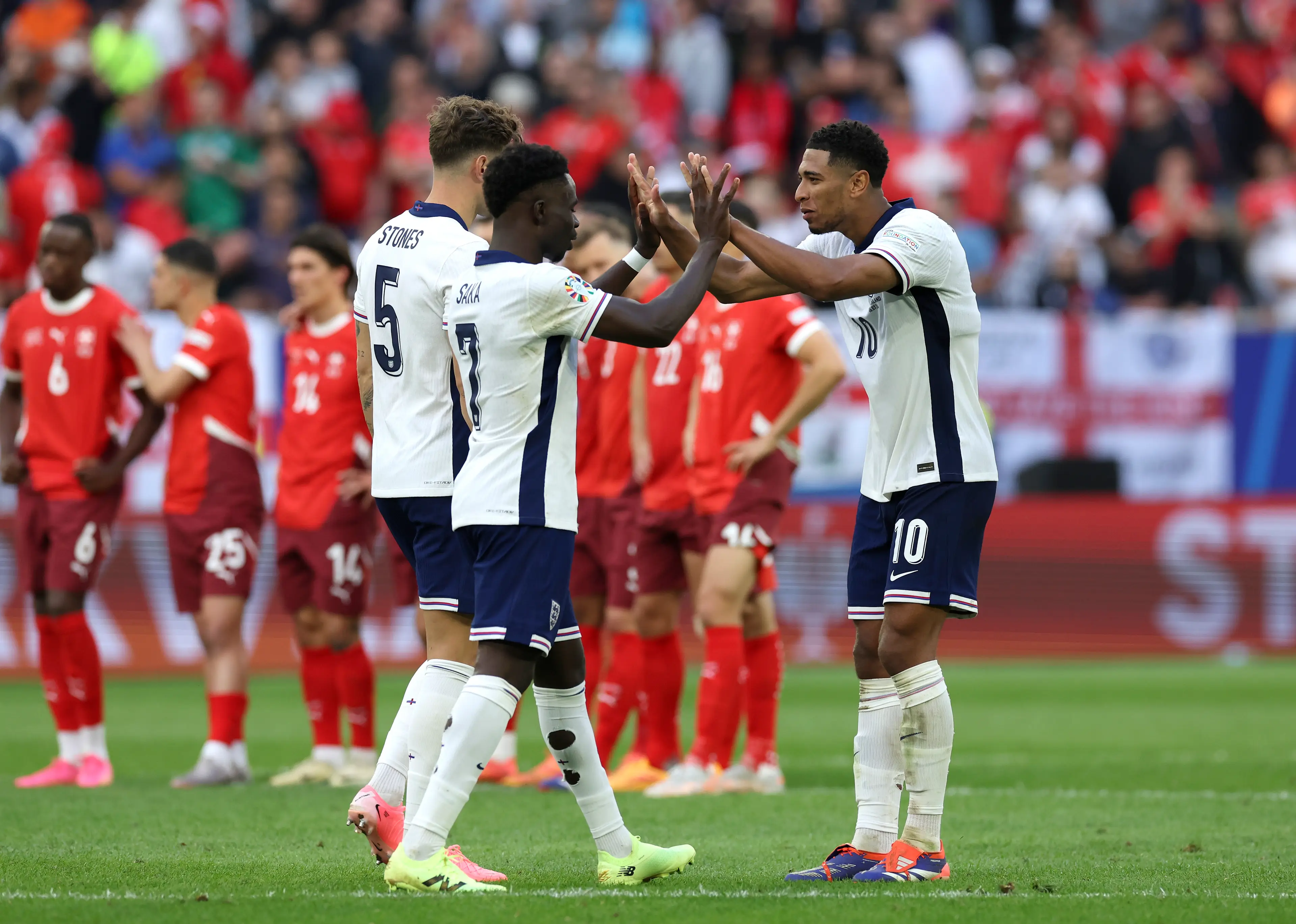 Jude Bellingham and Bukayo Saka celebrate England's victory over Switzerland at Euro 2024. Image: Getty