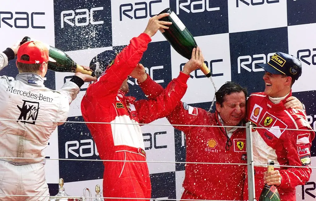 Michael Schumacher (pictured with Ferrari team principal Jean Todt) celebrates after winning the 1998 British GP (Image: Getty)