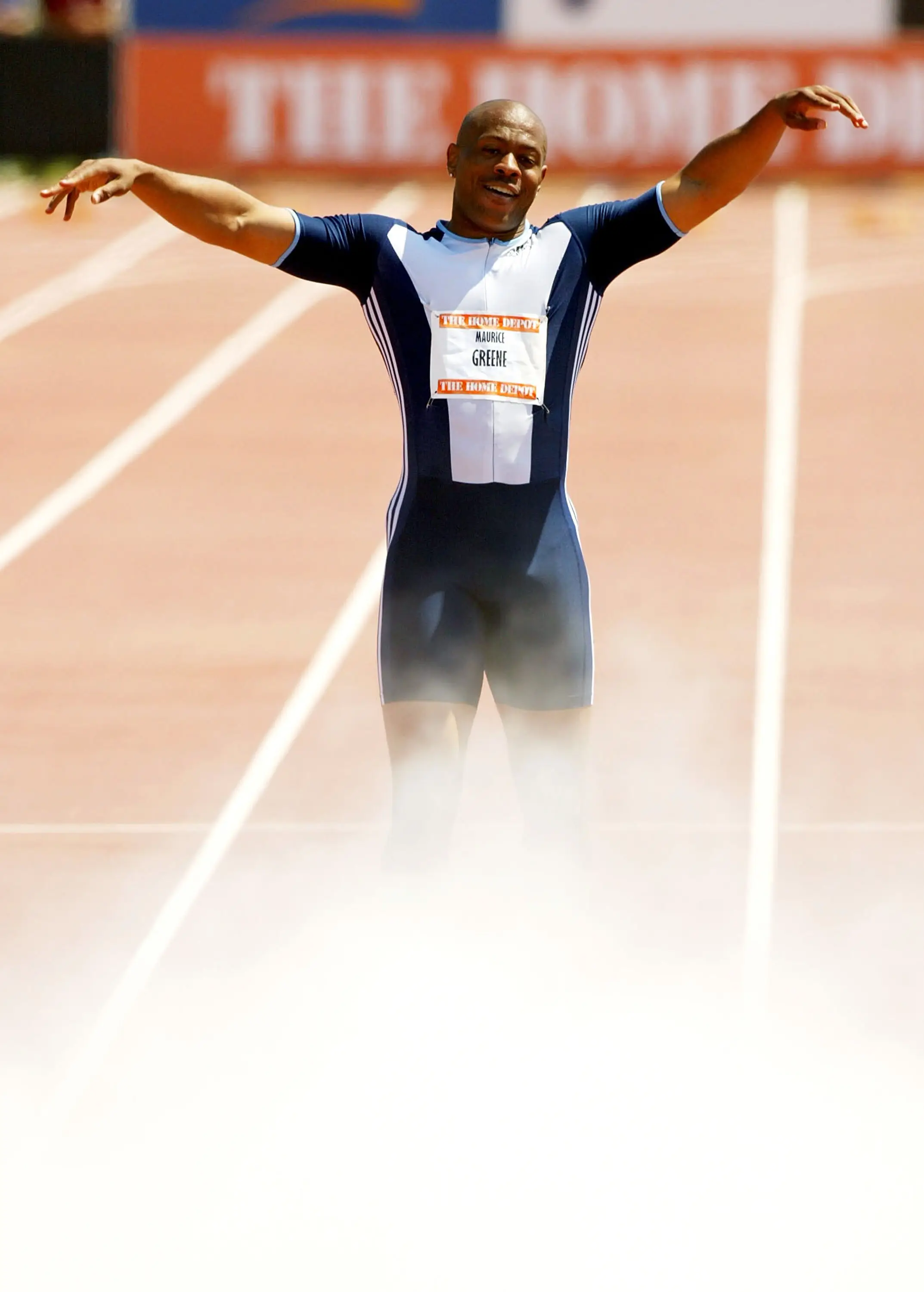 Maurice Greene celebrates as teammates spray his feet with a fire extinguisher after winning the men's 100m. Image: Getty