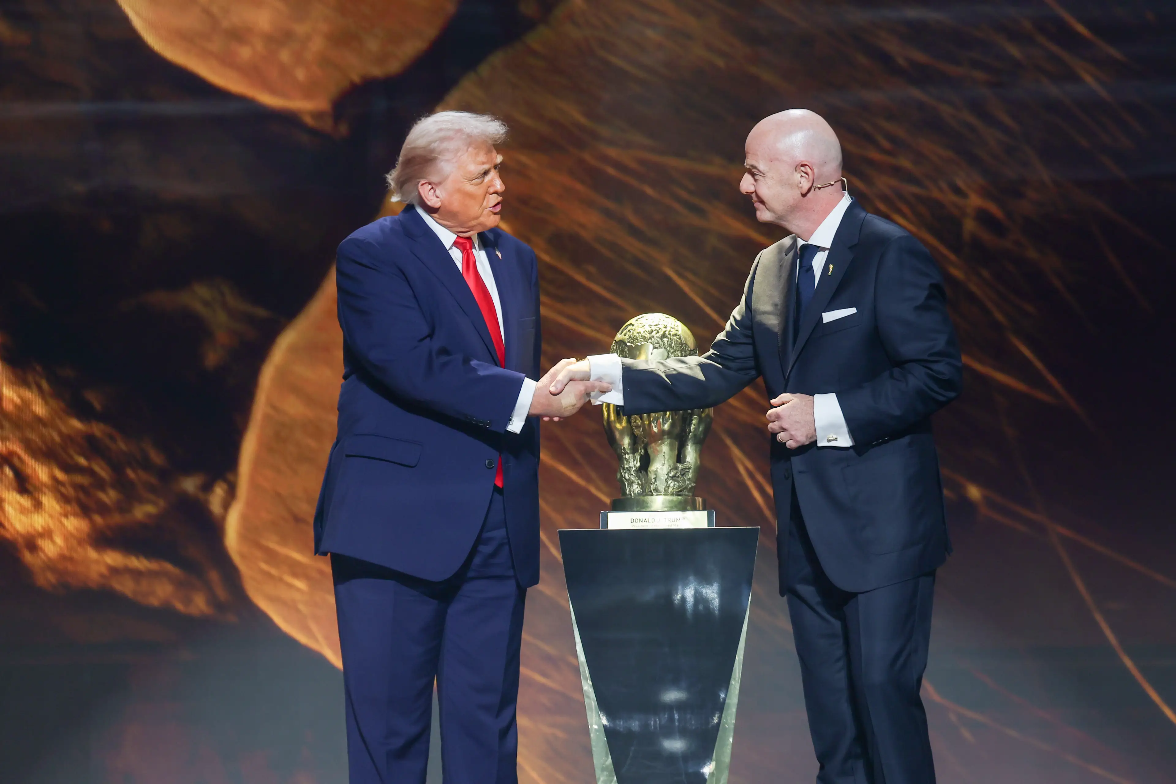 Donald Trump and Gianni Infantino shake hands at the official World Cup draw ceremony. Image: Getty 