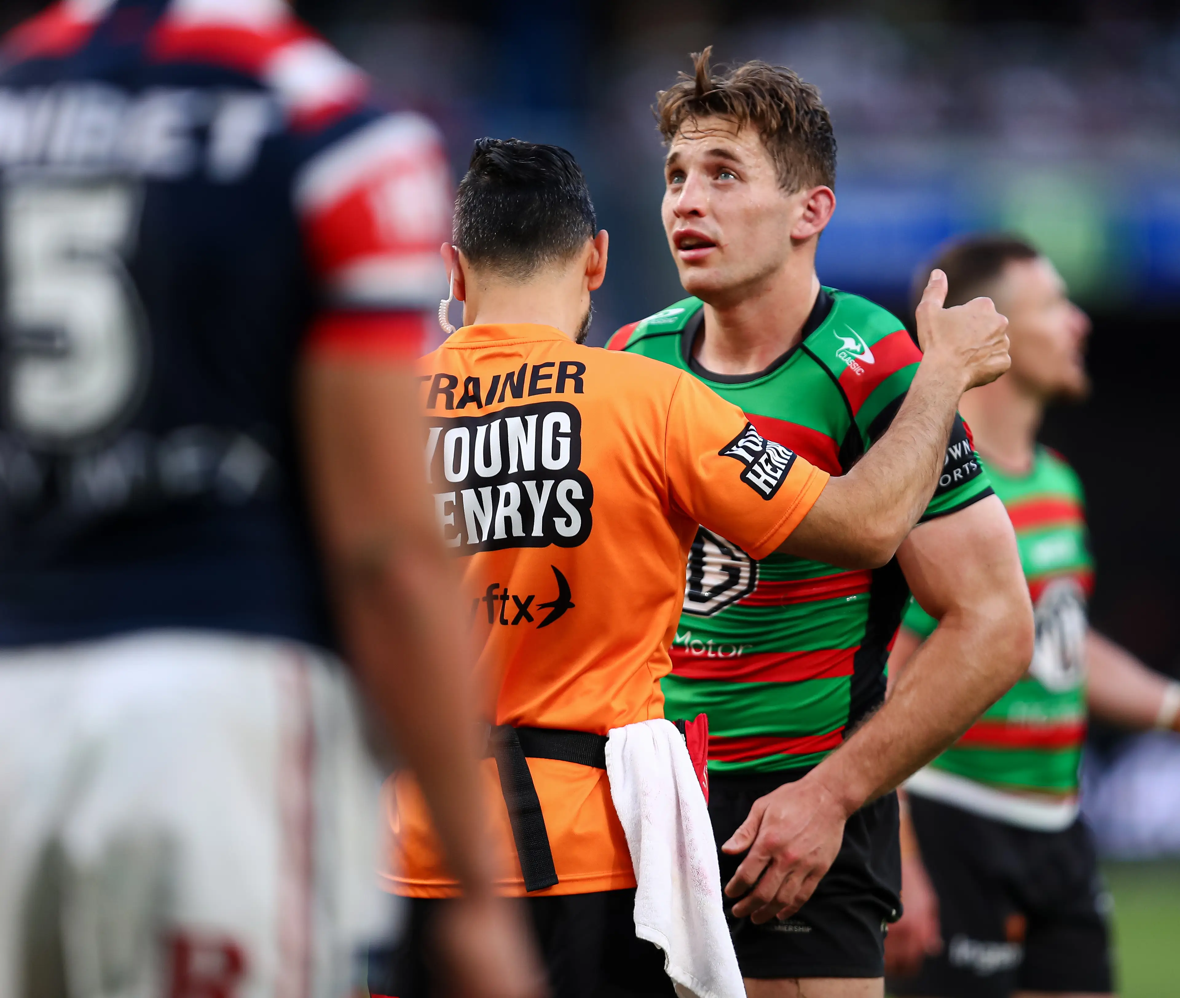 A trainer conducts a Head Injury Assessment on NRL star Cameron Murray.