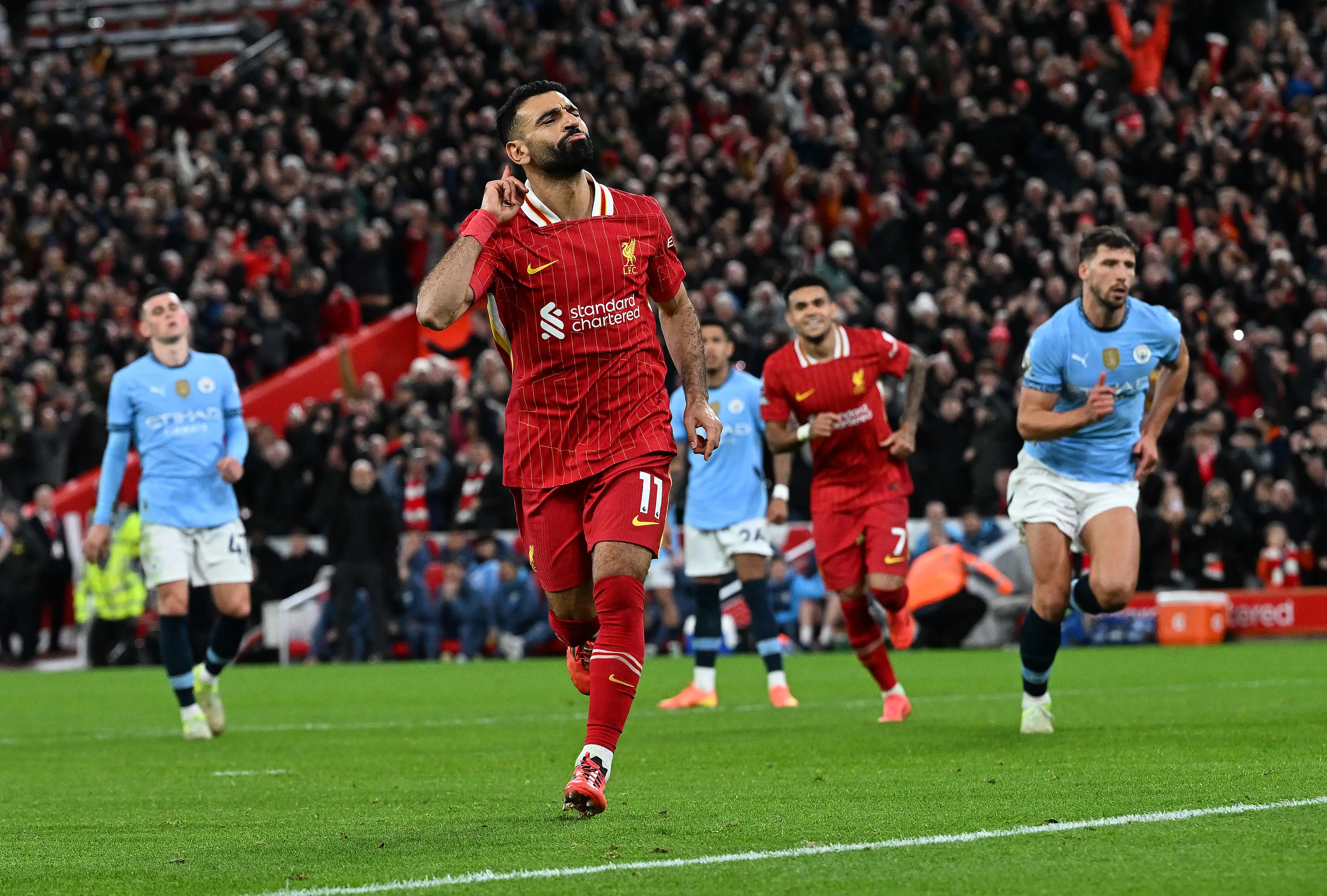 Mohamed Salah wheels away in celebration after scoring against Manchester City. Image: Getty