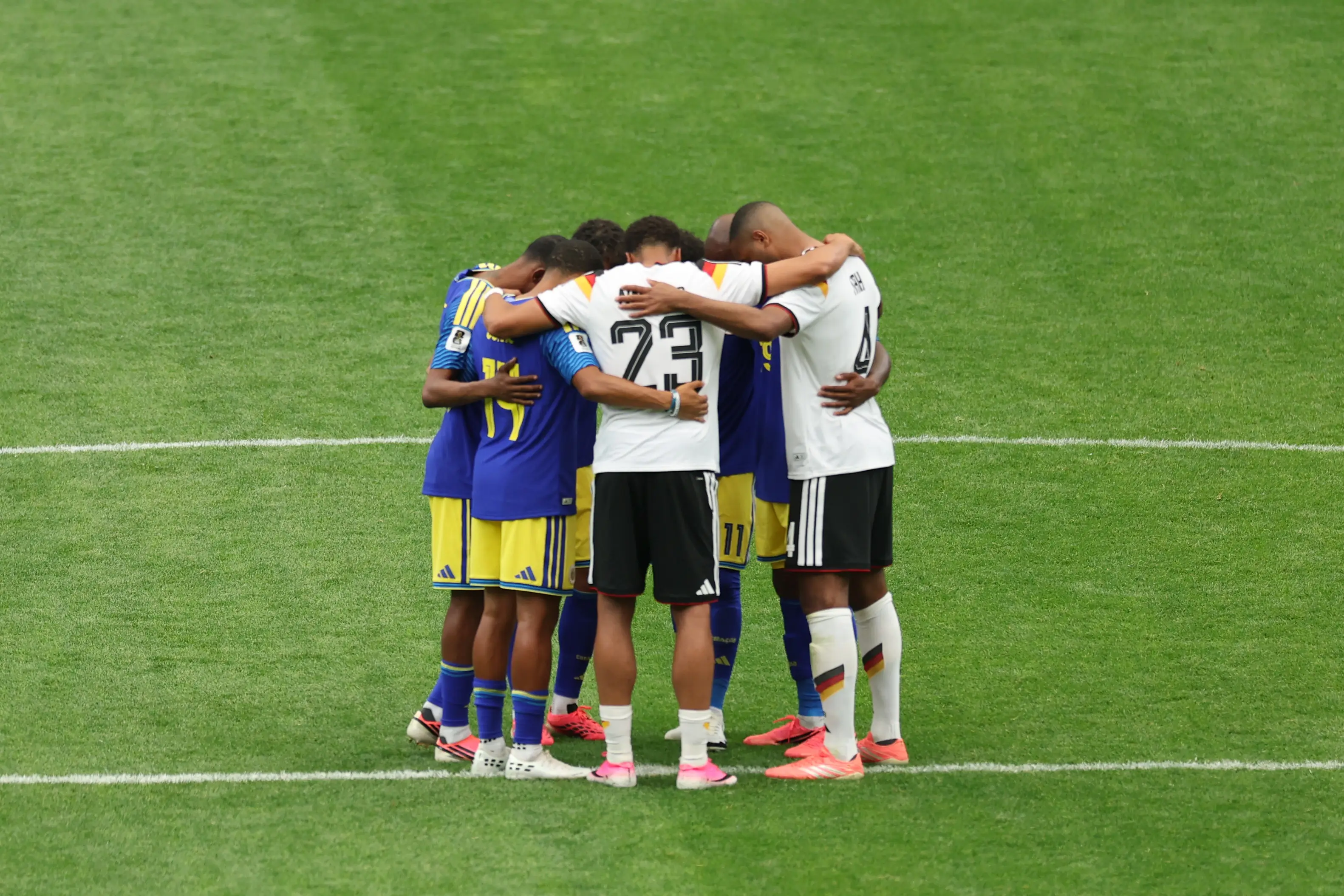 Germany and Curacao players form a huddle after the final whistle. Image credit: Getty