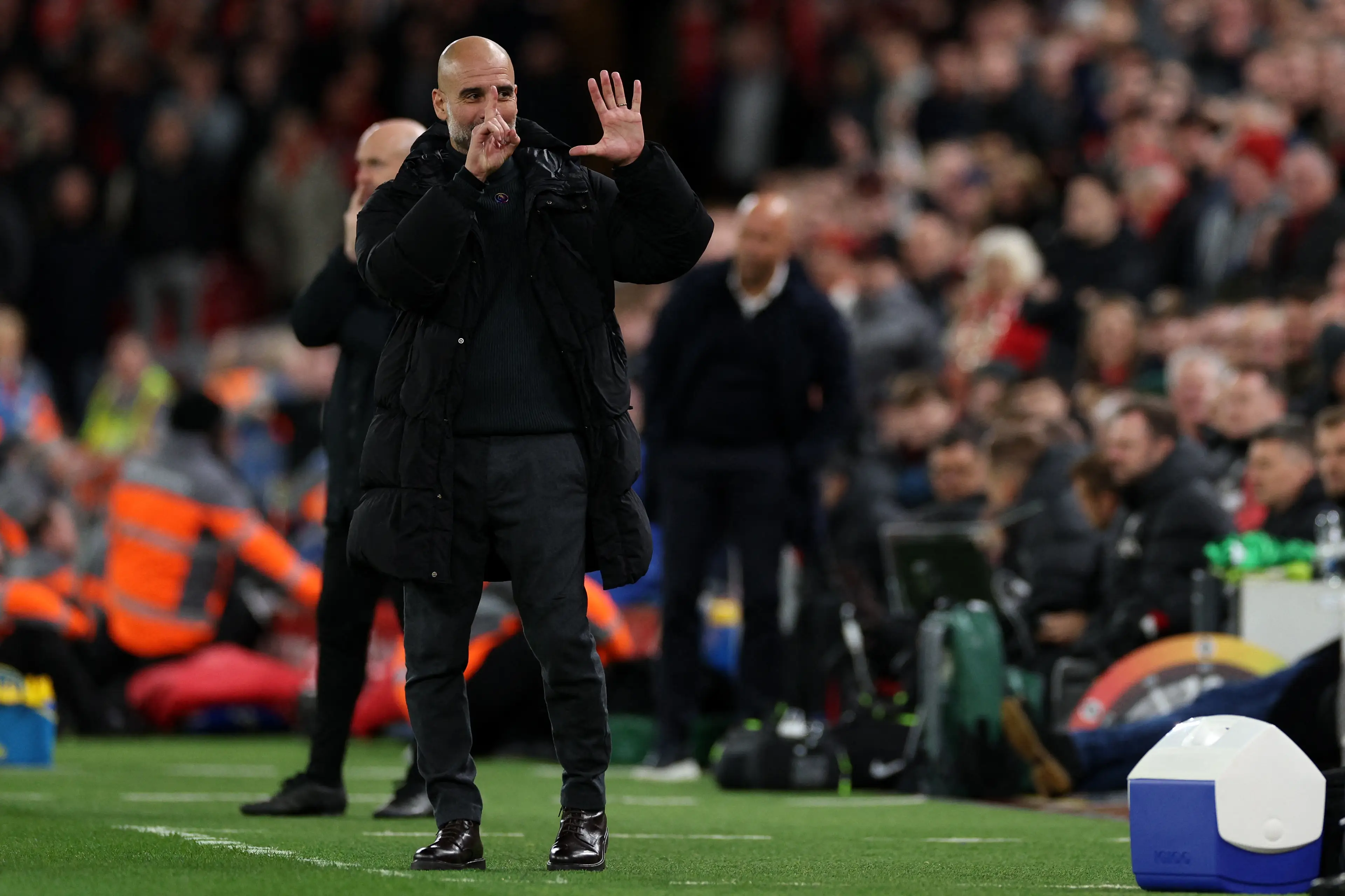 Pep Guardiola reacts to Liverpool fans chanting 'you're getting sacked in the morning'. Image: Getty