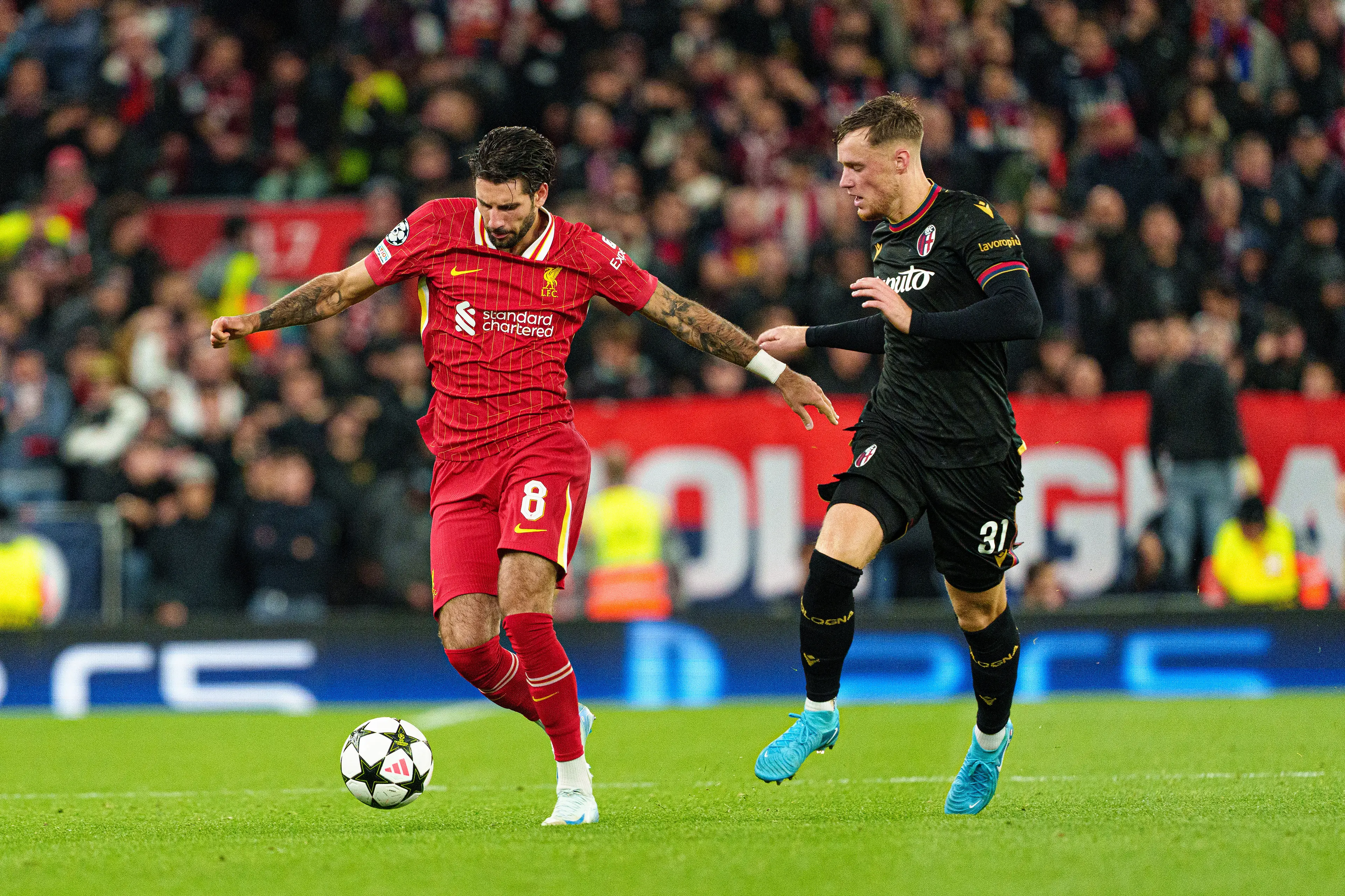 Liverpool's Dominik Szoboszlai is in action with Bologna's Sam Beukema during the UEFA Champions League match between Liverpool and Bologna FC 1909 (Getty Images)
