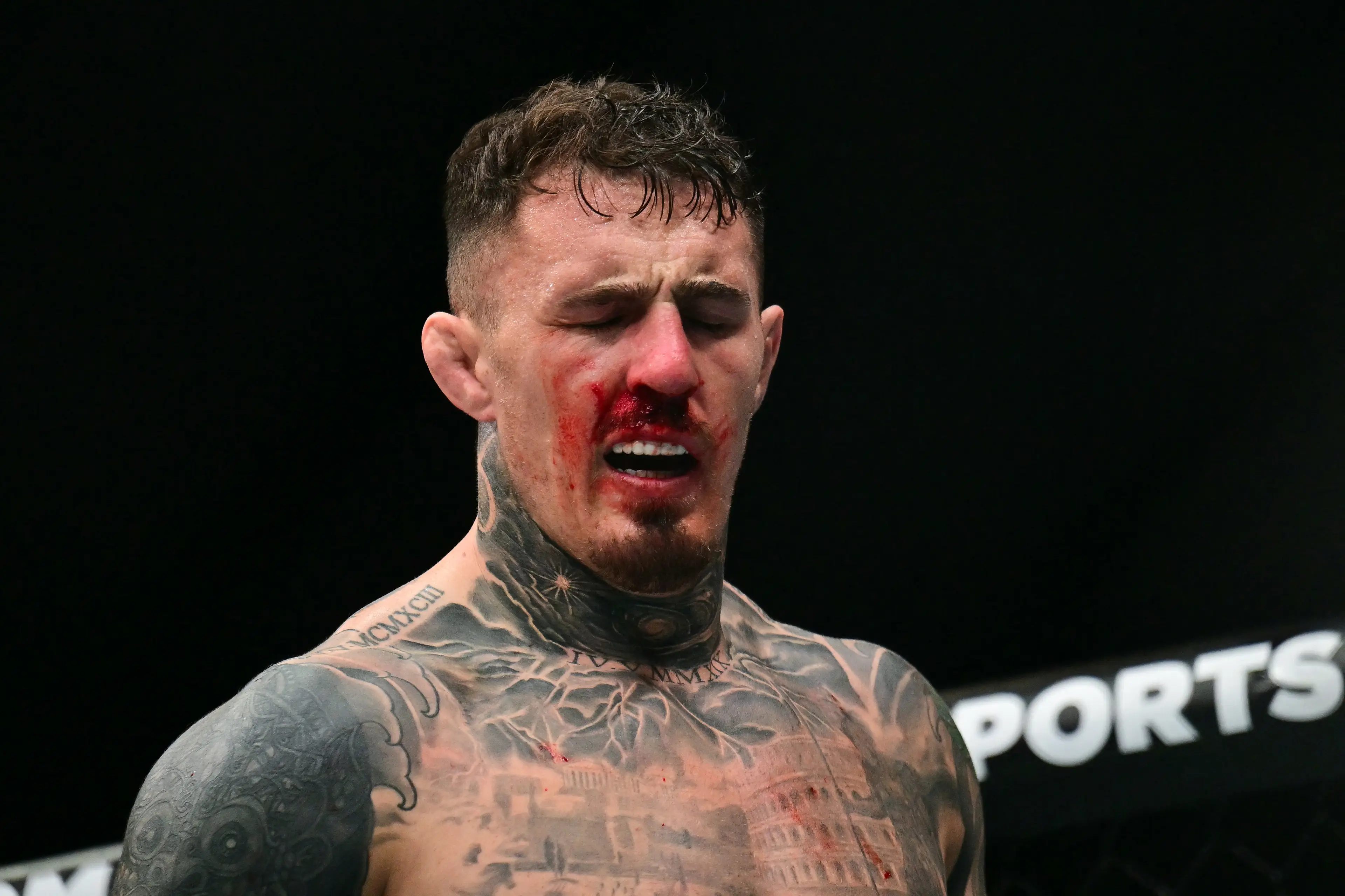 Tom Aspinall reacts after being poked in the eye at UFC 321. Image: Getty 